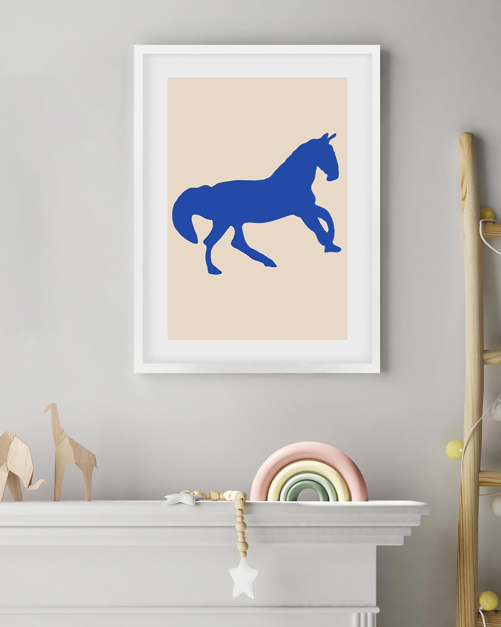 Framed artwork of a blue horse on a beige background in a child's room.