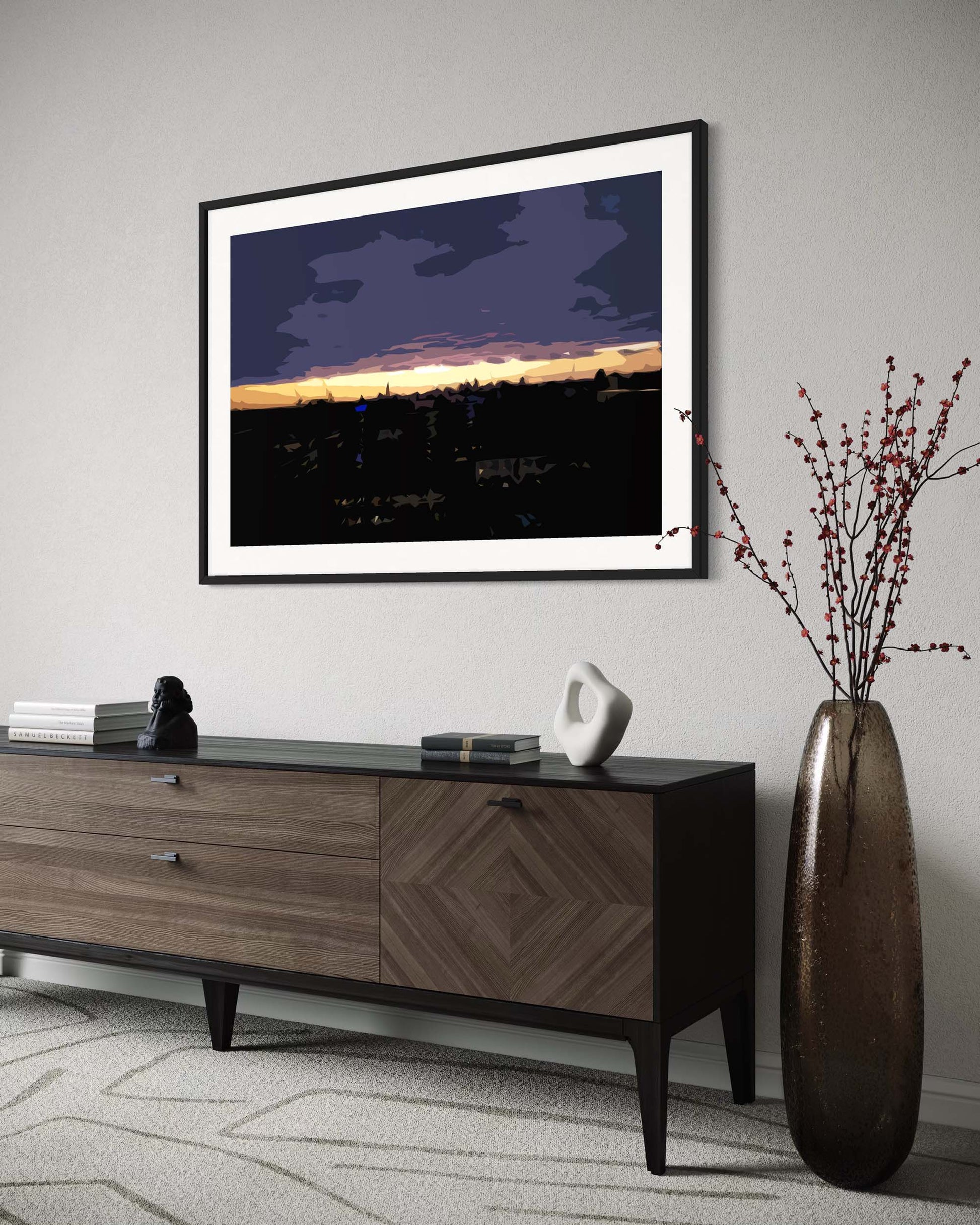 Framed artwork above a wooden console table in a living room setting.