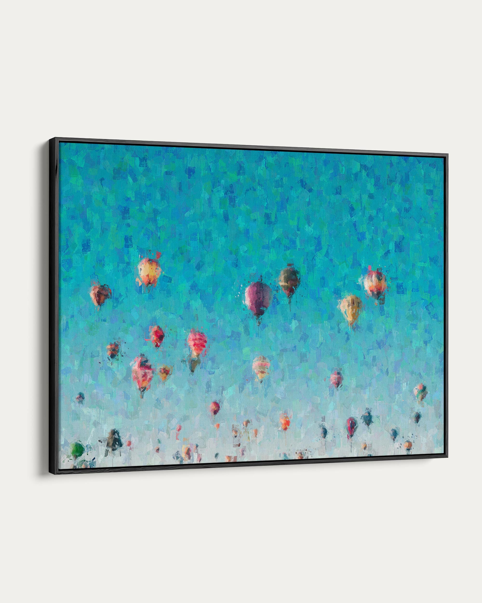 Framed artwork of colorful hot air balloons against a blue sky.