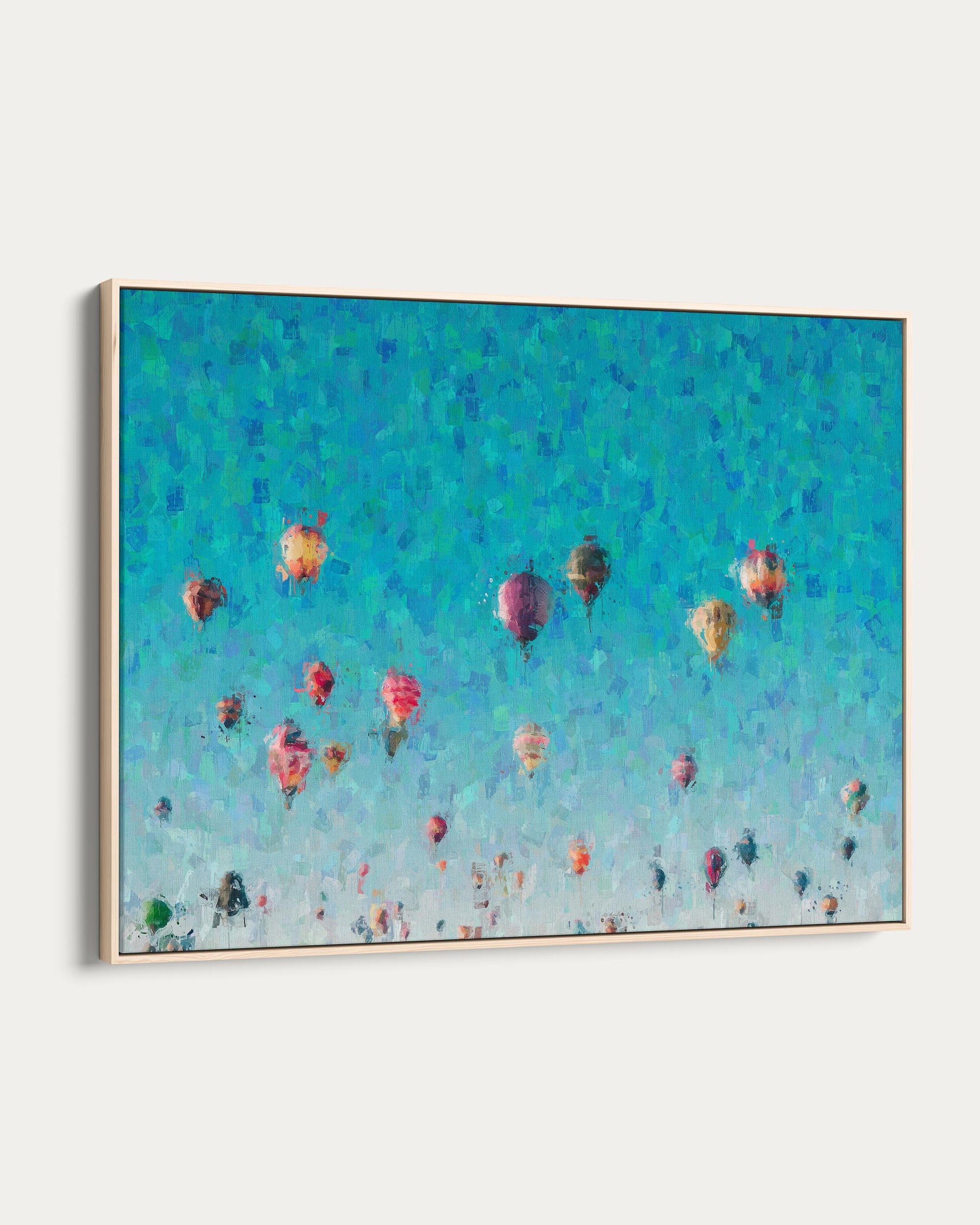 Framed artwork of colorful hot air balloons against a blue sky.