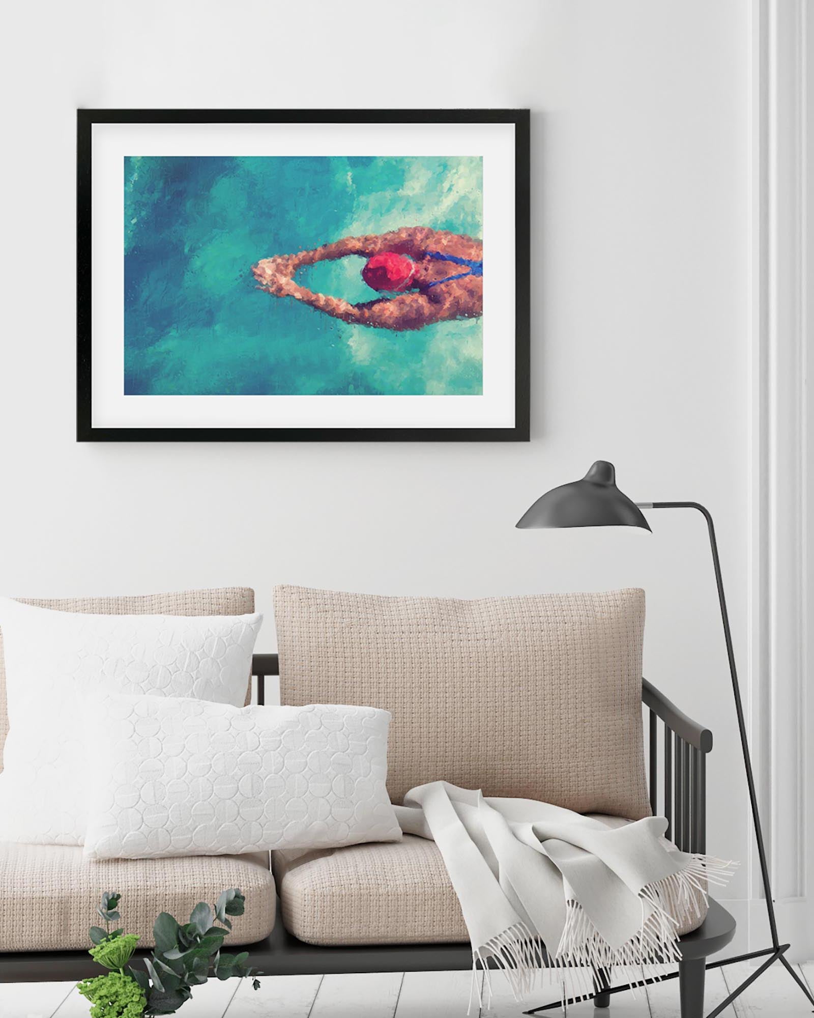 Framed artwork of a person swimming in a heart shape above water in a living room.