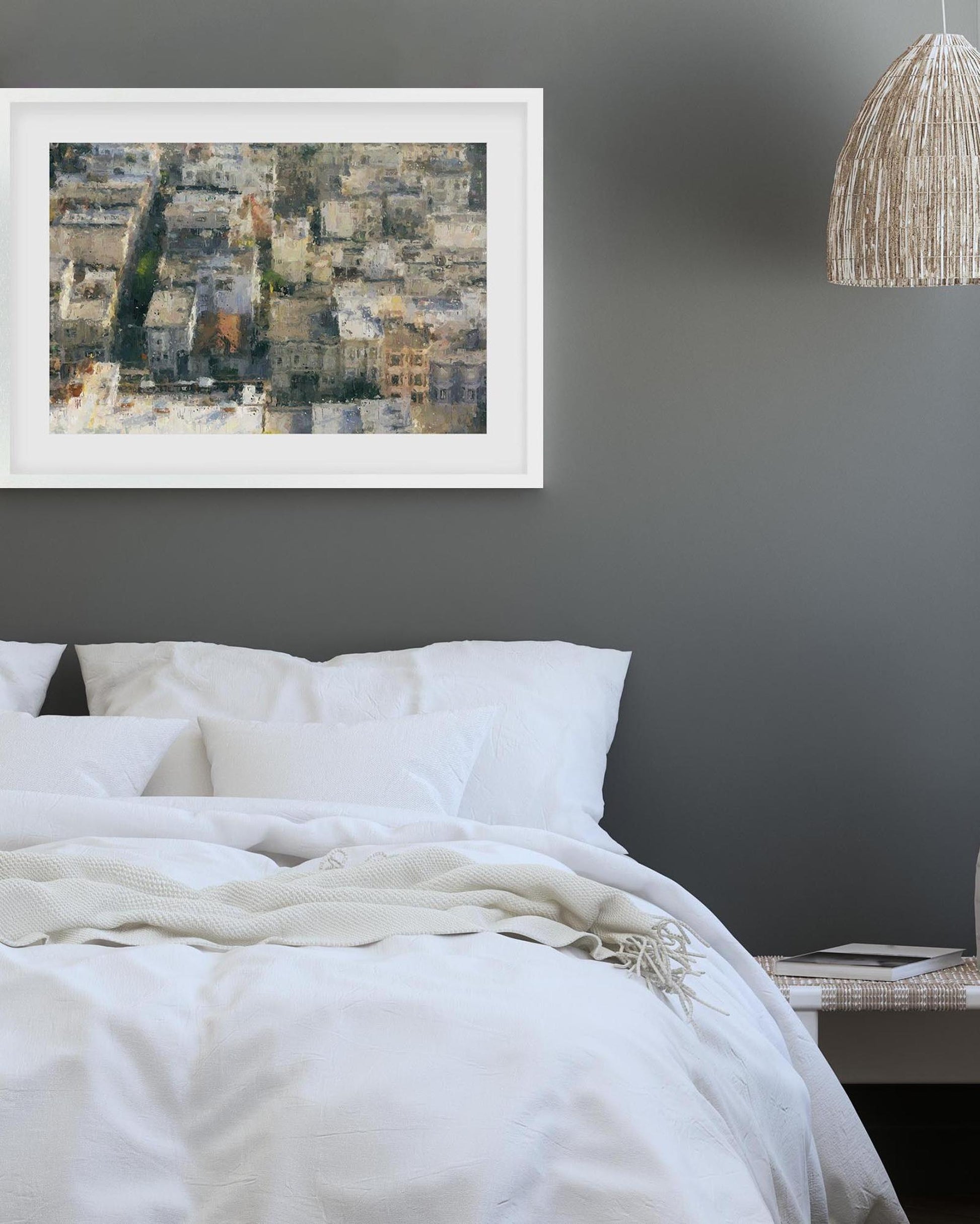 Framed abstract art above a bed in a bedroom setting