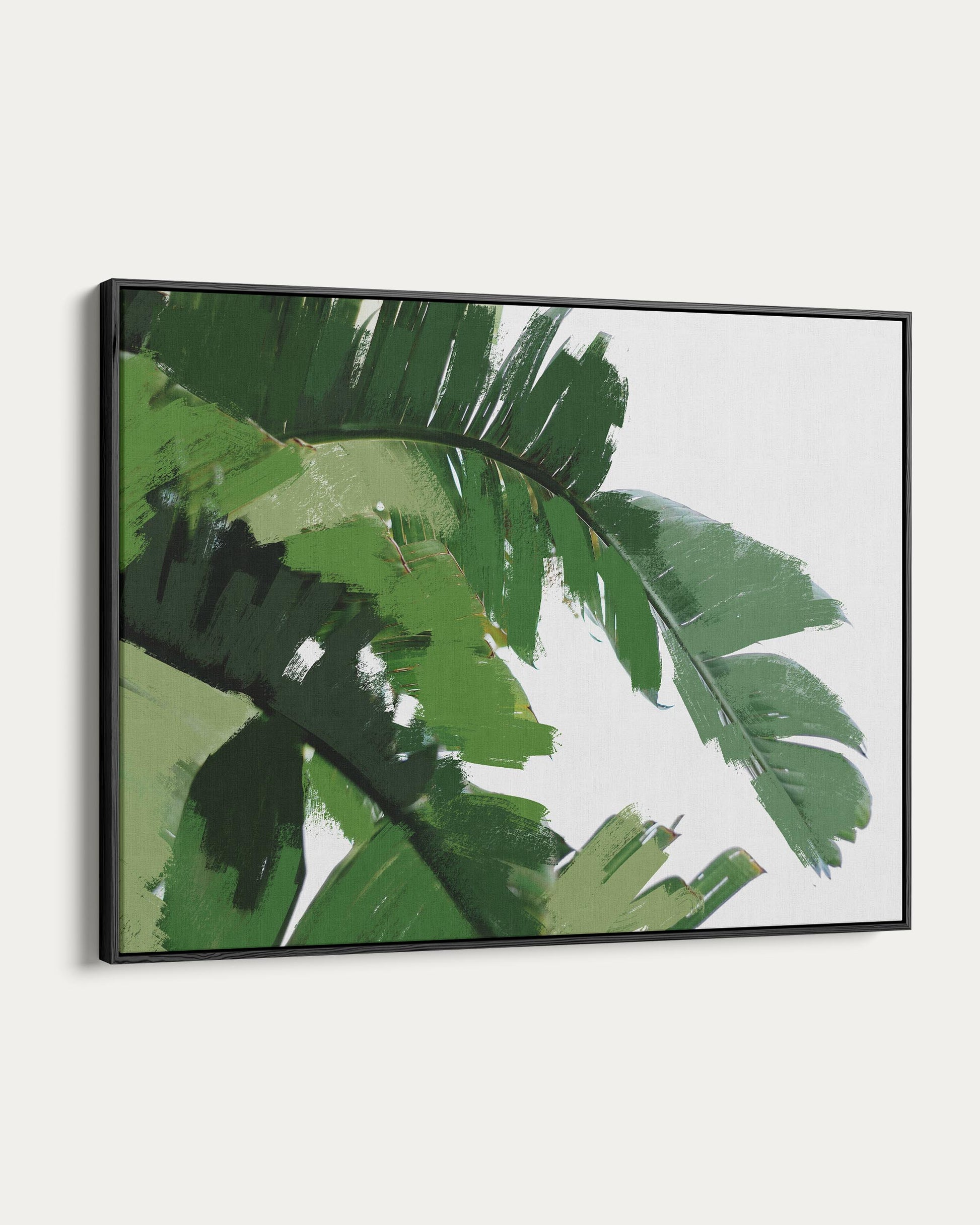 Framed artwork of green leaves on a white background