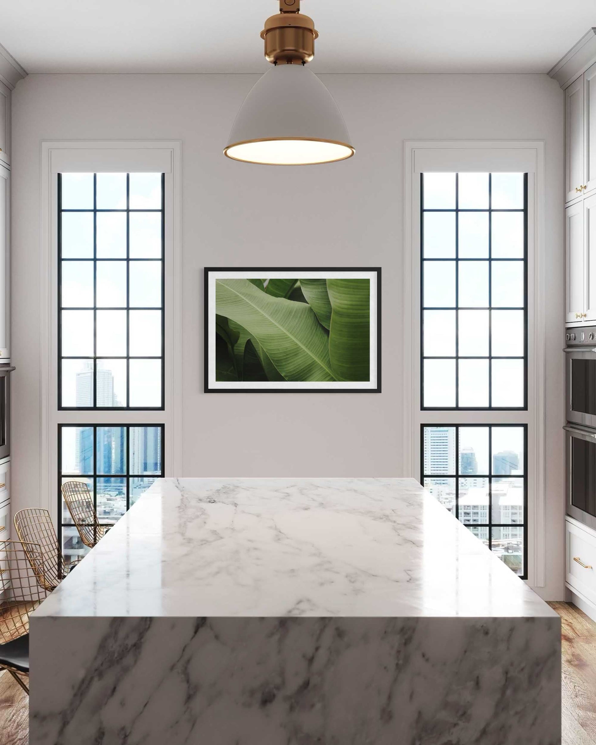 Modern kitchen with marble island, large windows, and a green leafy plant artwork.