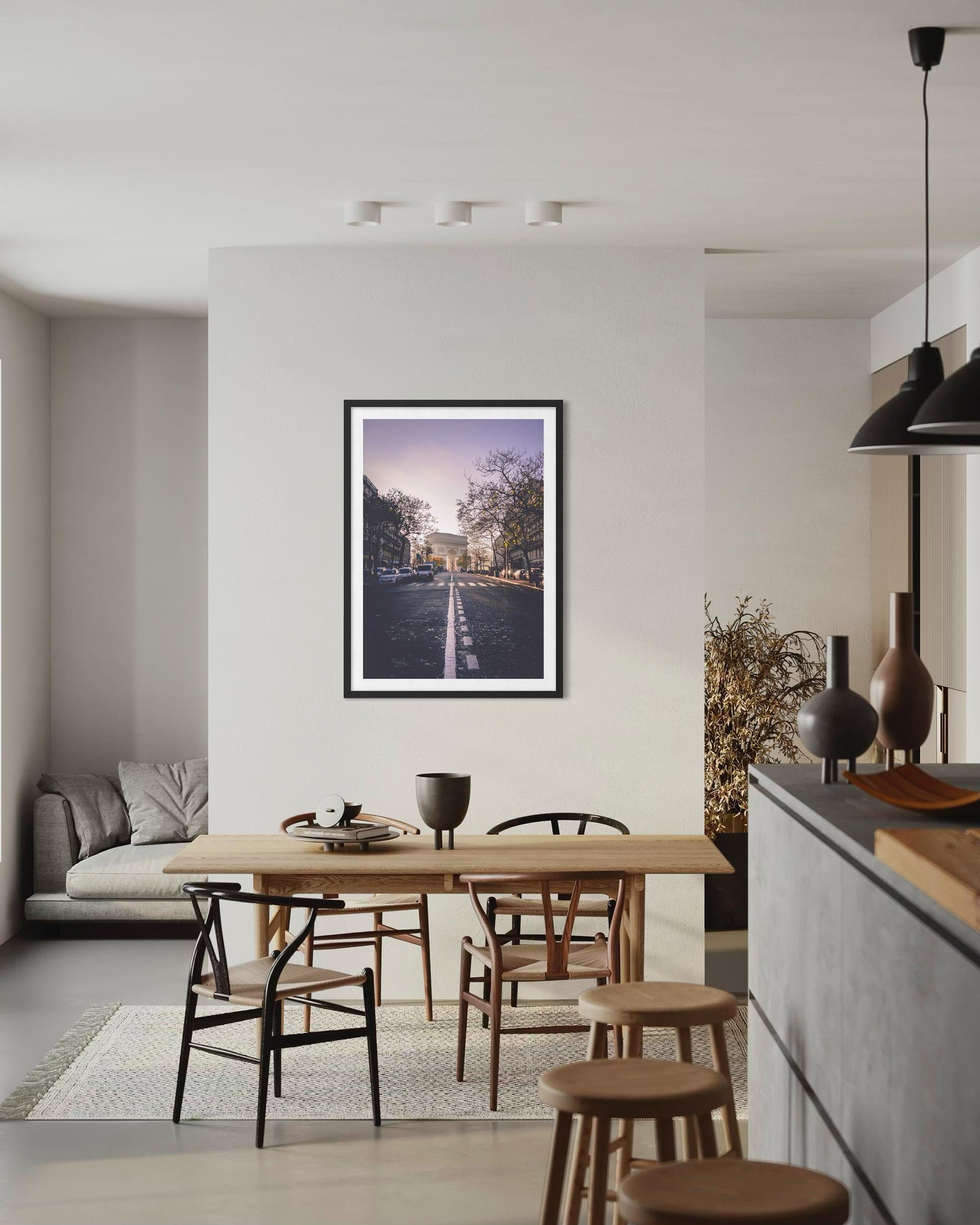 Modern kitchen with a dining table and chairs, featuring a framed picture on the wall.
