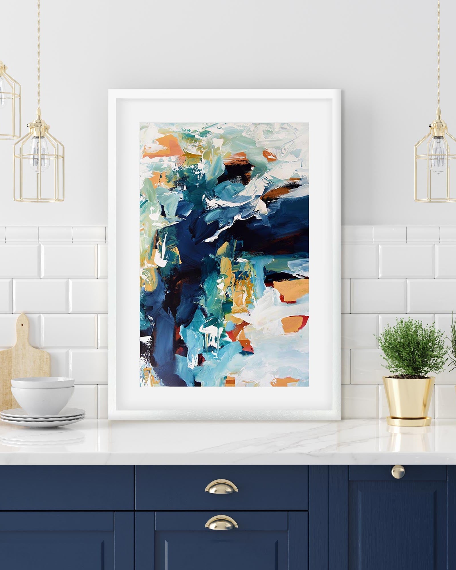 blue abstract print in a white frame in kitchen 