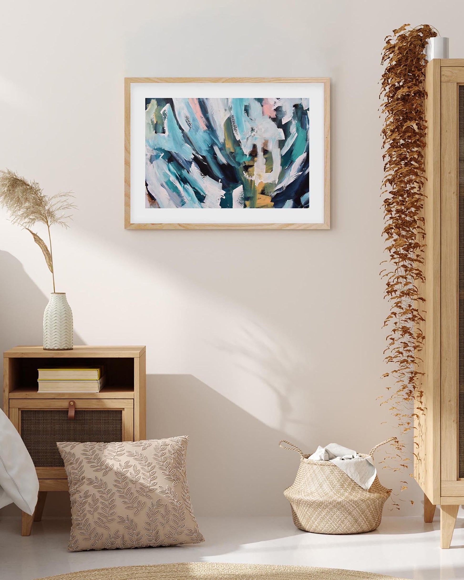 Framed abstract art piece on a wall with decorative elements in a room.