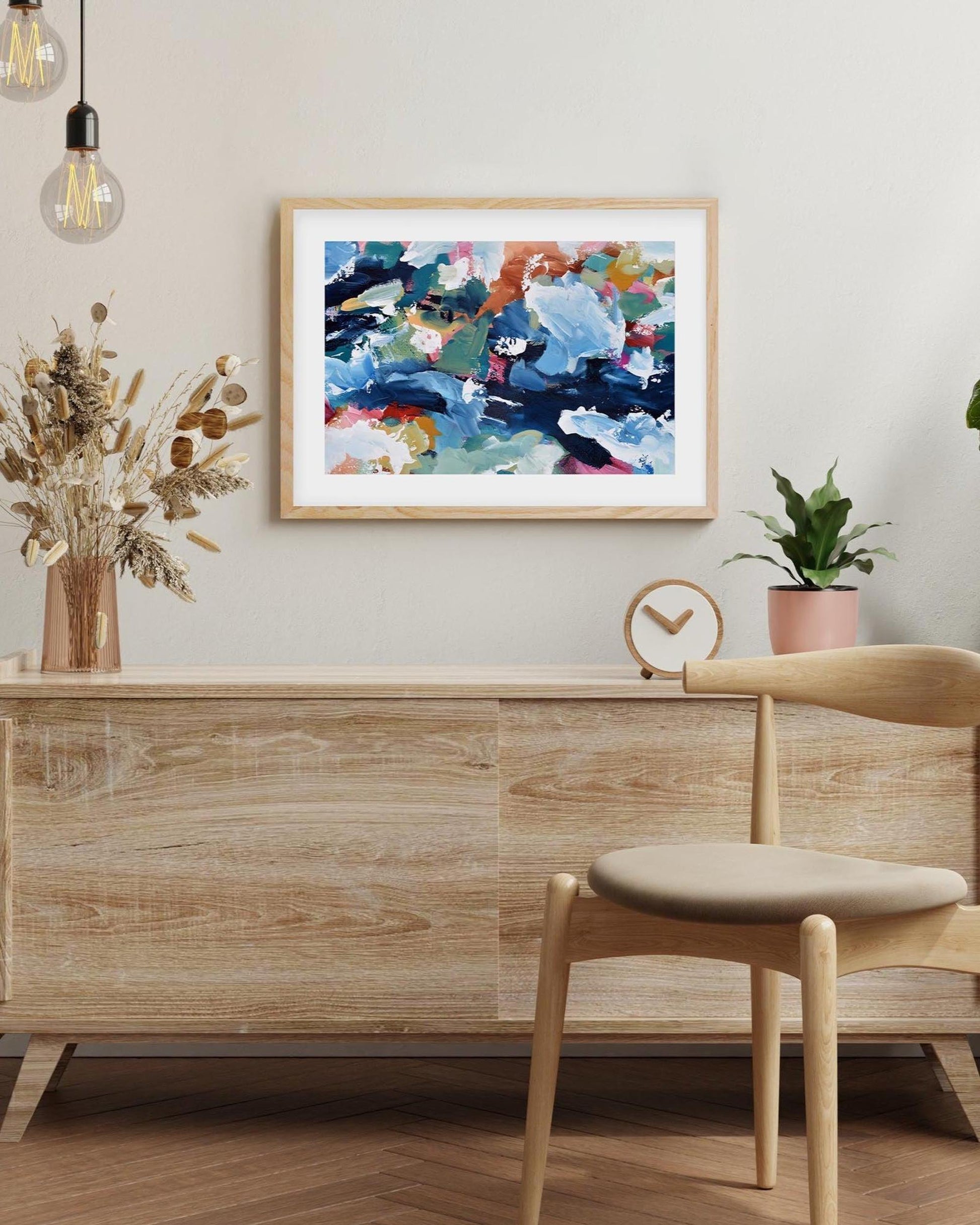 Modern interior with wooden furniture, abstract art, and decorative elements.