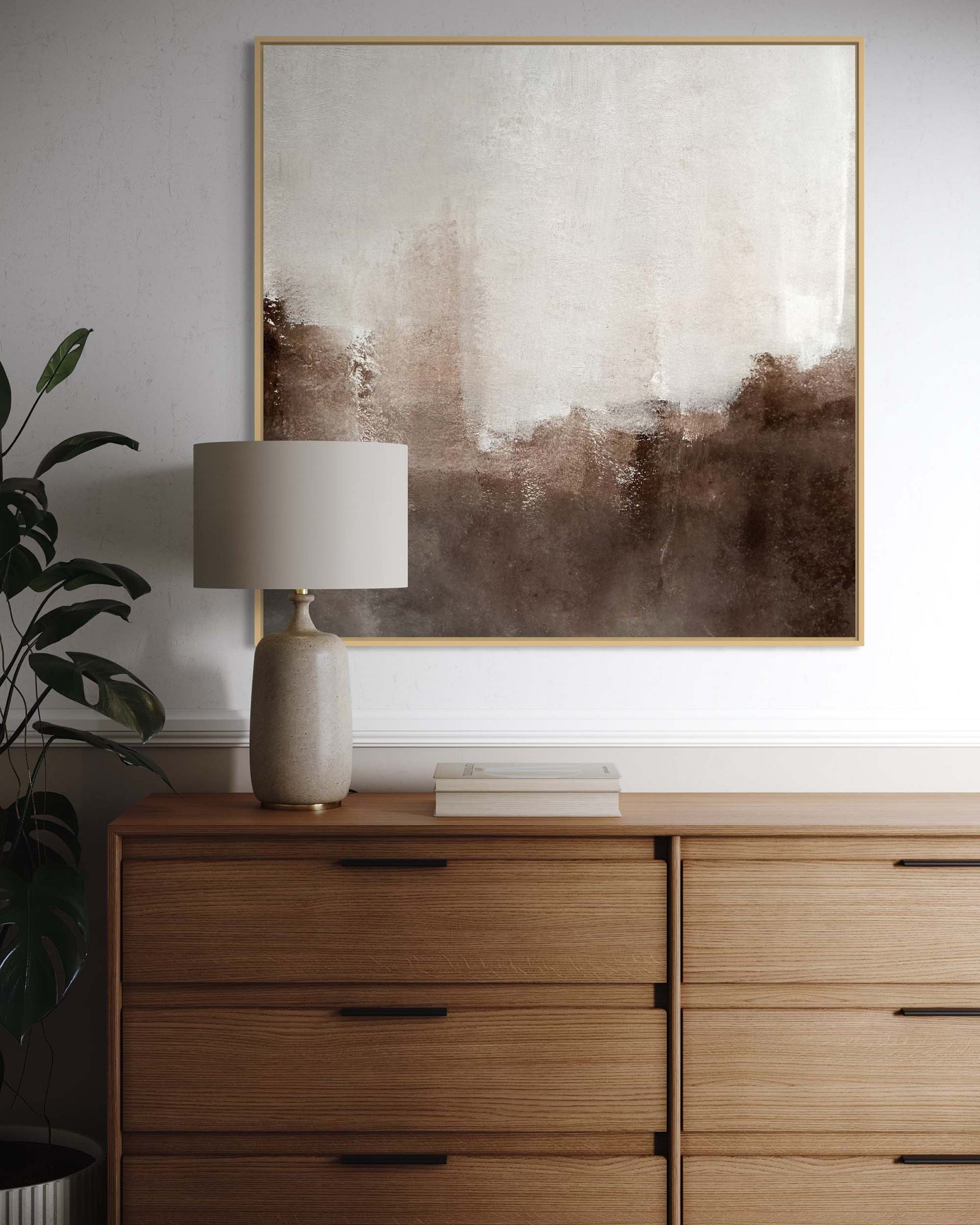Wooden dresser with a lamp and abstract painting on the wall