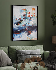 Living room with a green sofa, abstract painting, and decorative elements.