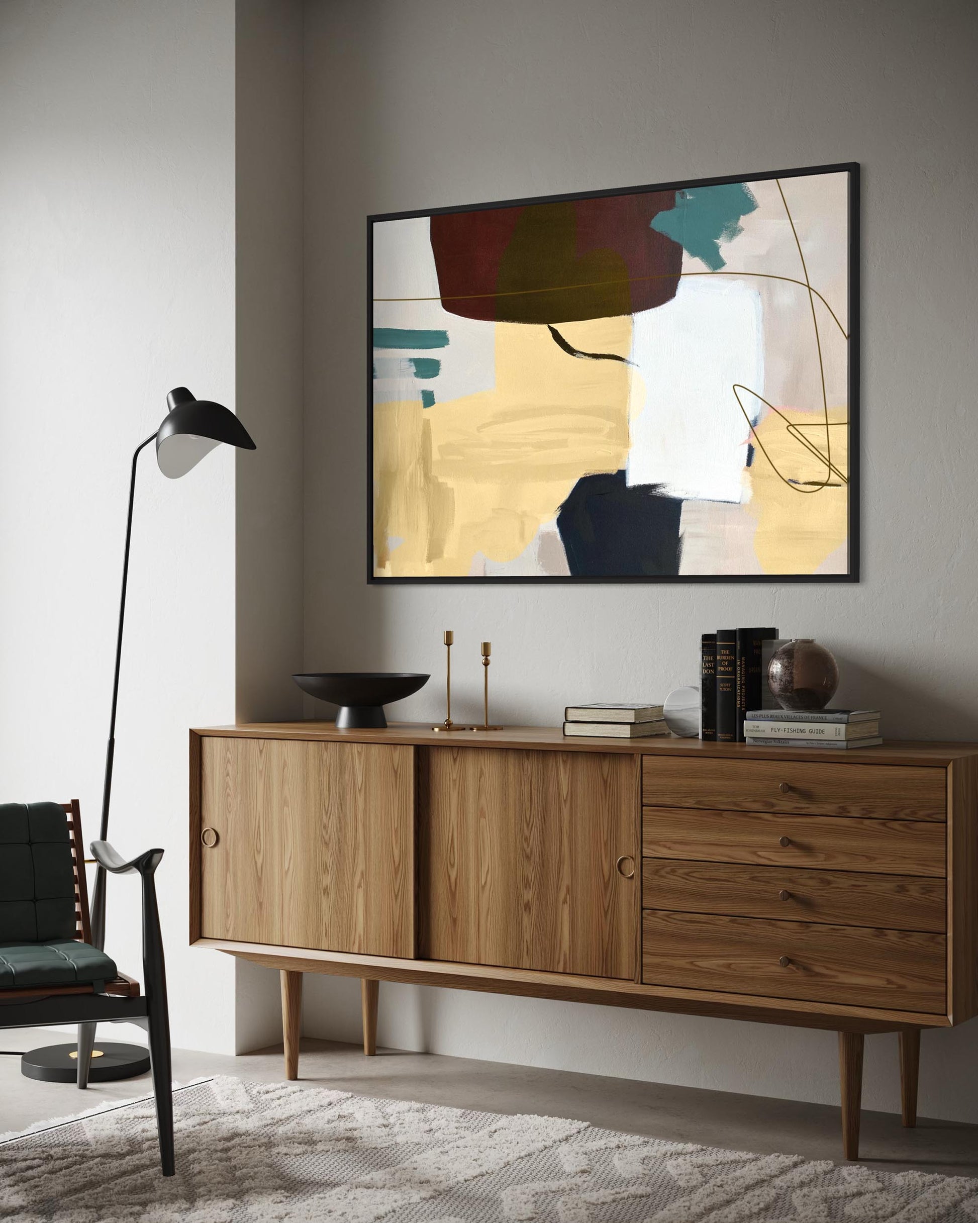 Wooden sideboard with abstract art on the wall in a modern interior setting.