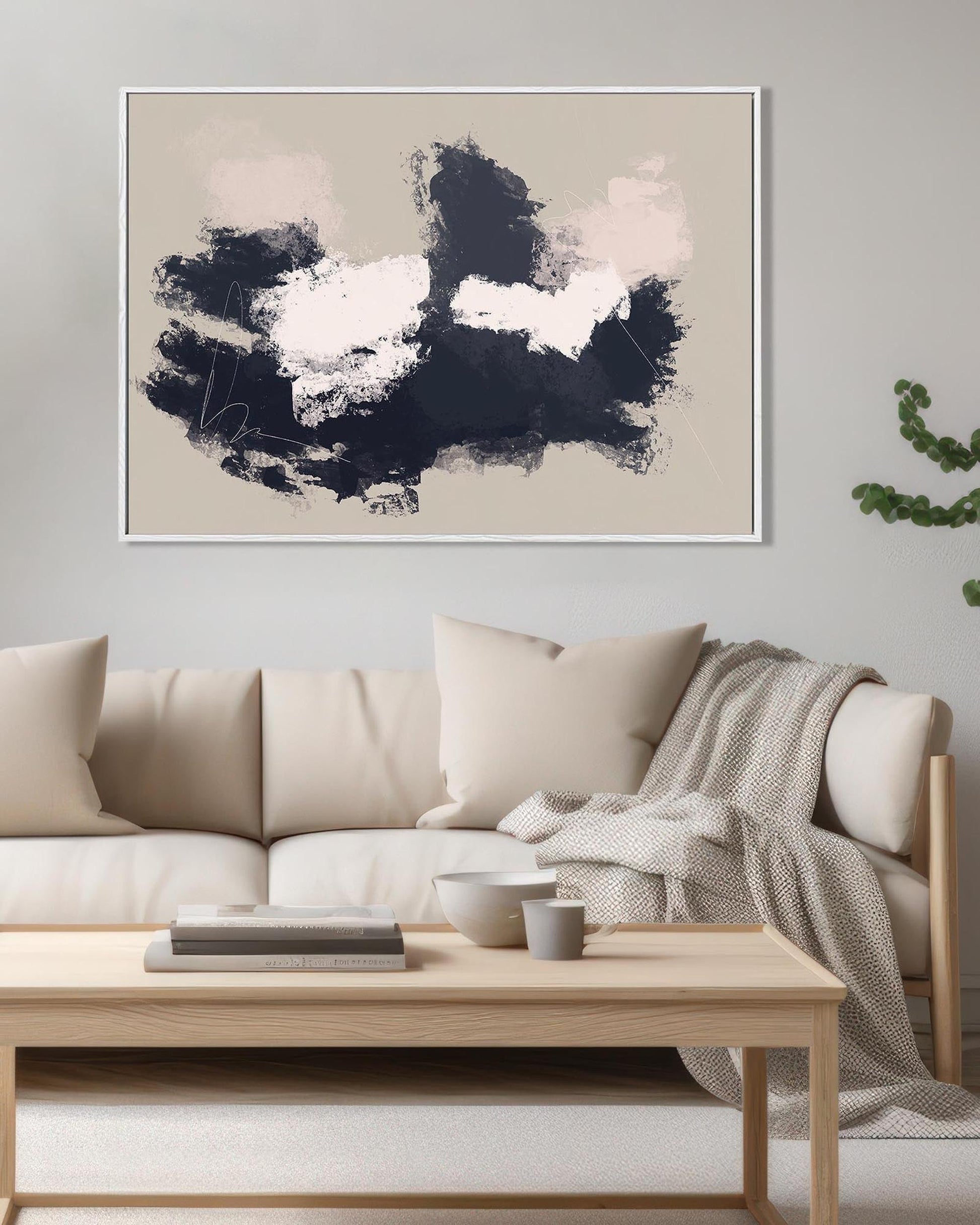 Modern living room with a beige sofa, wooden coffee table, and abstract art on the wall.