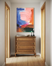 Wooden dresser with abstract painting above it in a room with open doors.