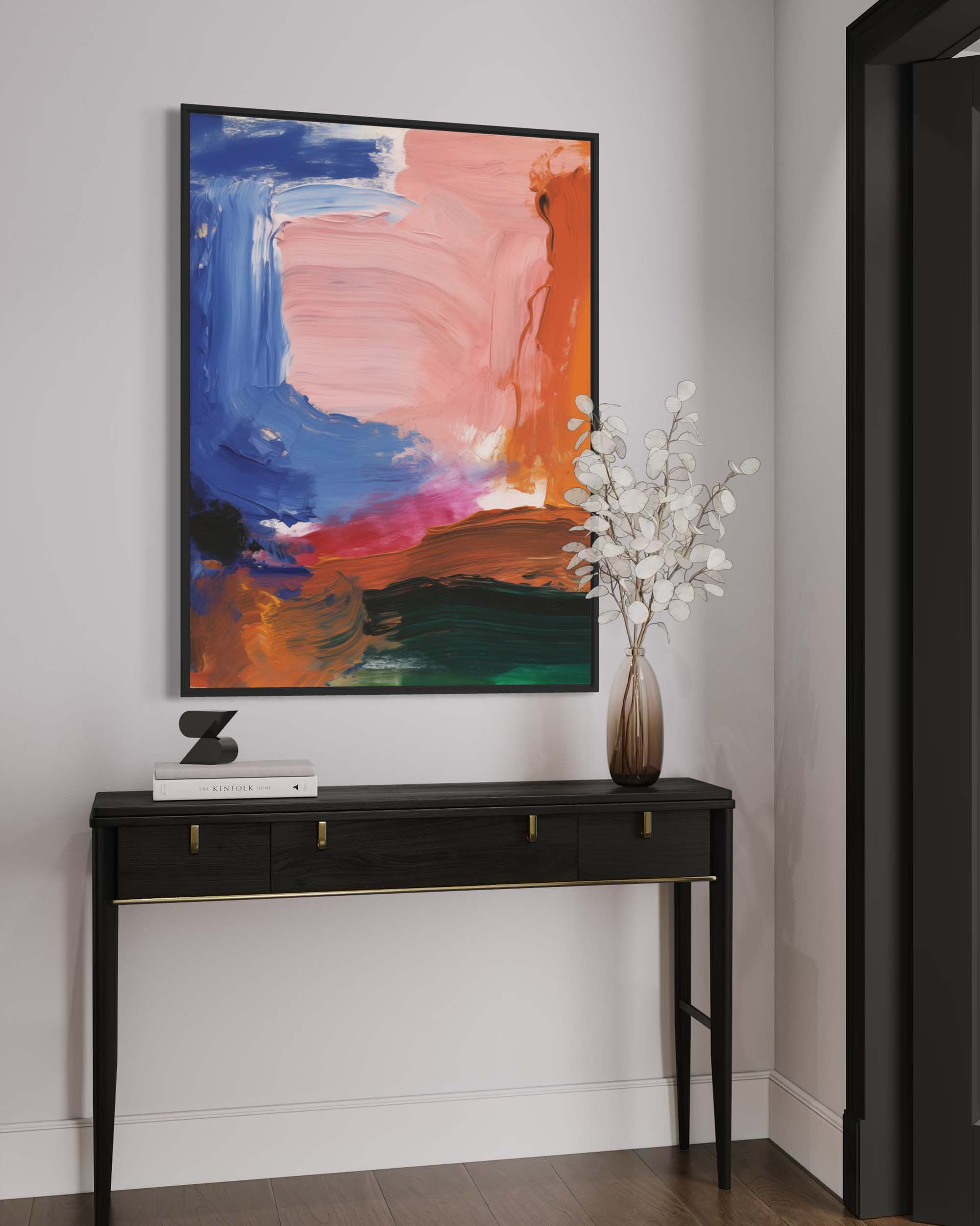 Colorful abstract painting on a wall above a black console table with a vase of flowers.