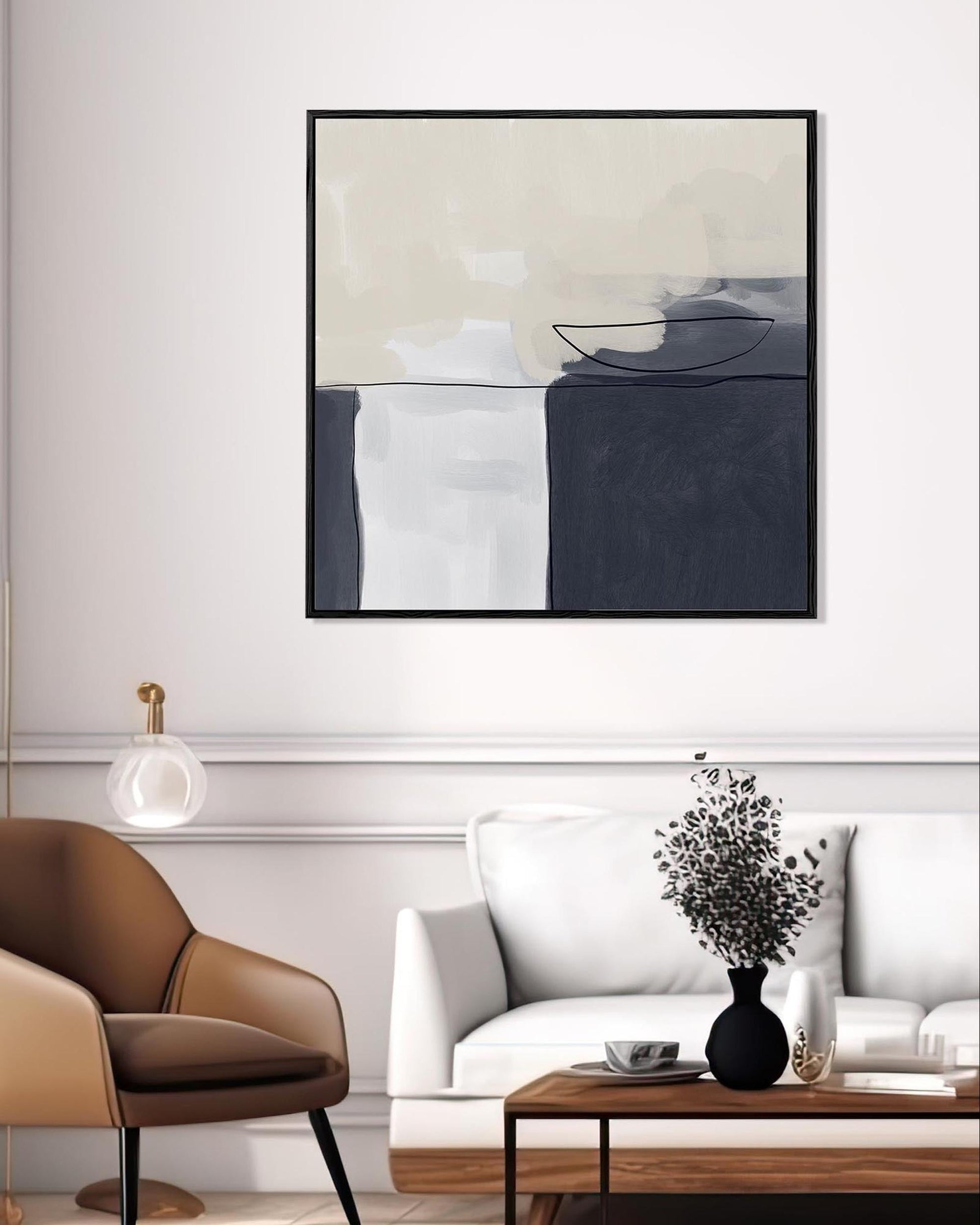 Modern living room with abstract art, white sofa, brown armchair, and wooden coffee table.