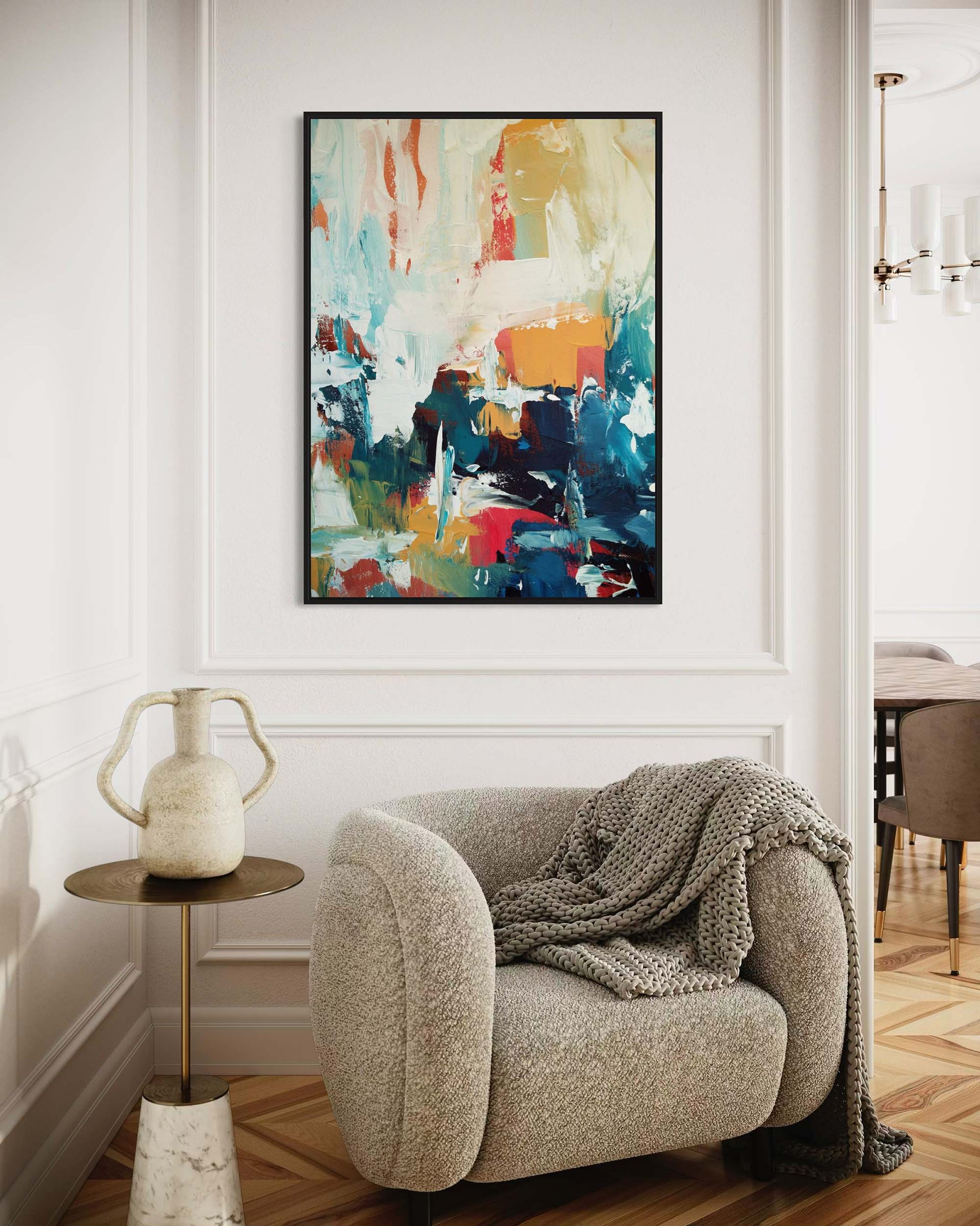 Modern interior with a colorful abstract painting on the wall, a textured armchair, and a small table.