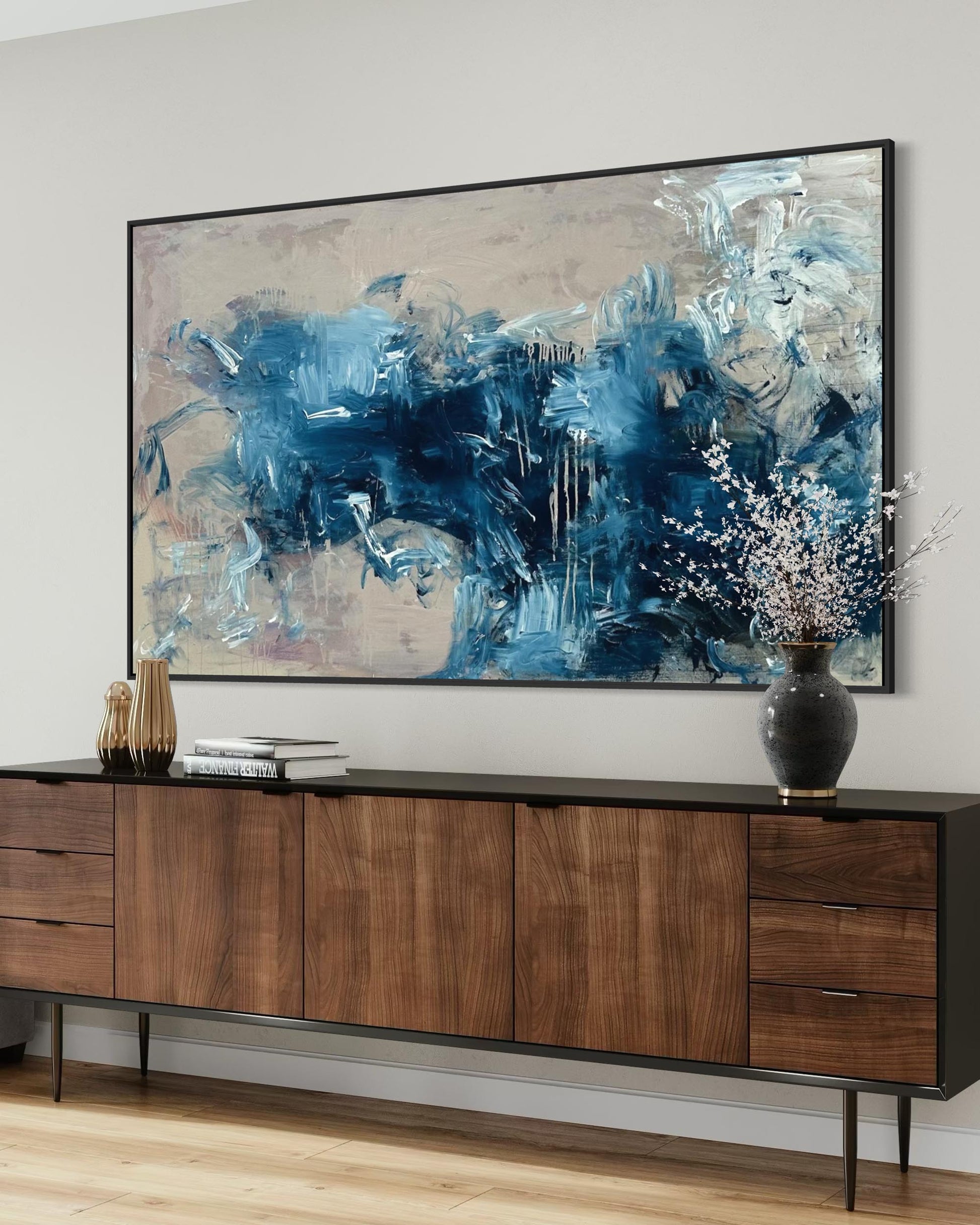 Wooden sideboard with abstract painting above it in a room.