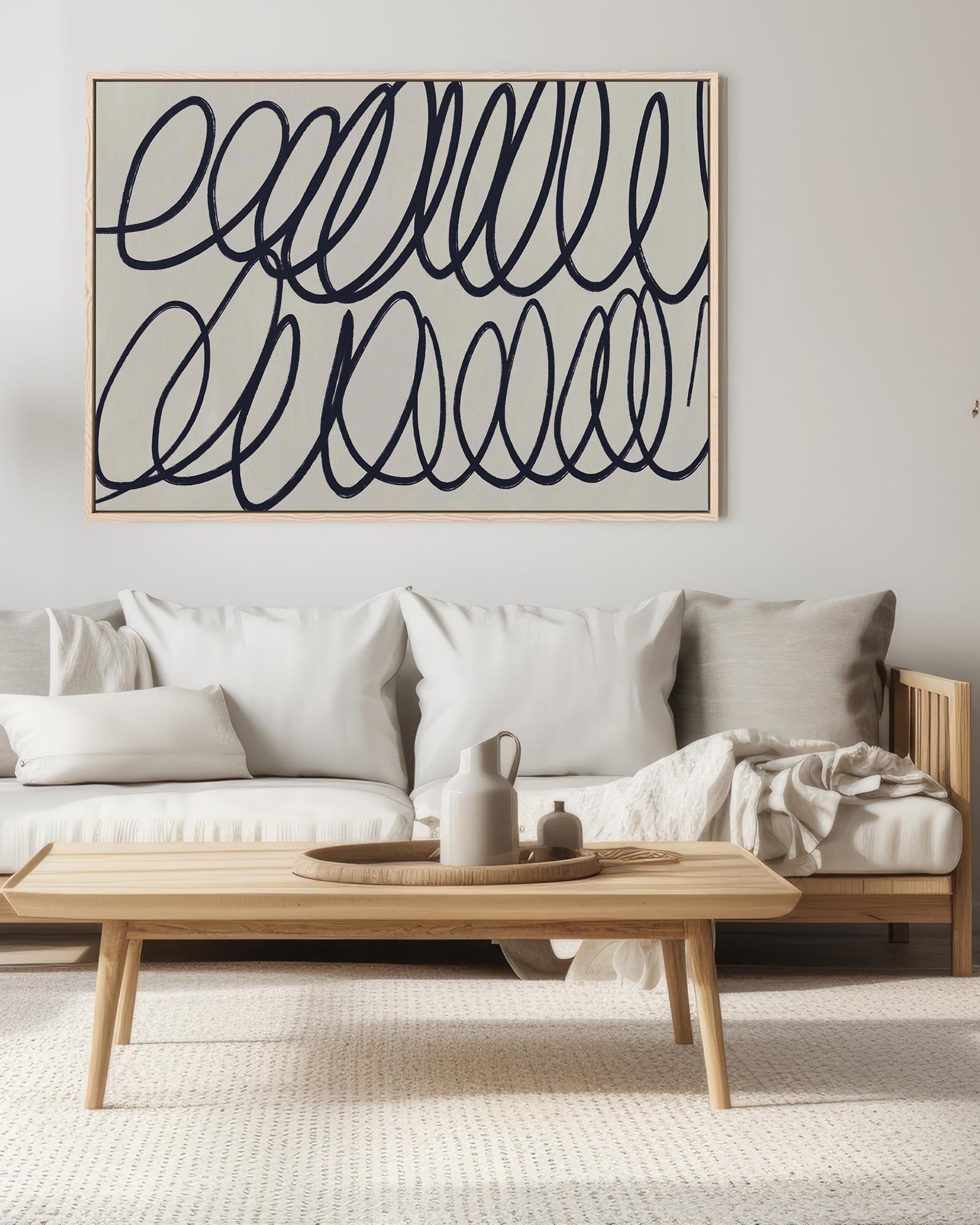 Modern living room with a sofa, coffee table, and abstract wall art.
