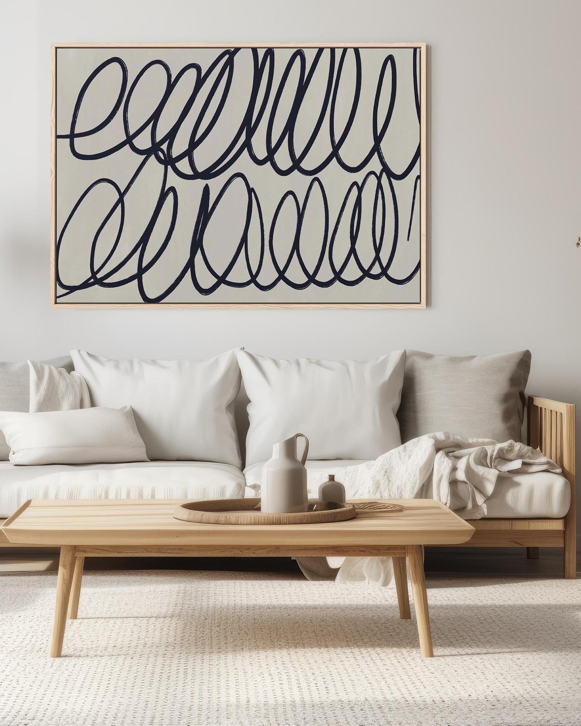 Modern living room with a sofa, coffee table, and abstract wall art.