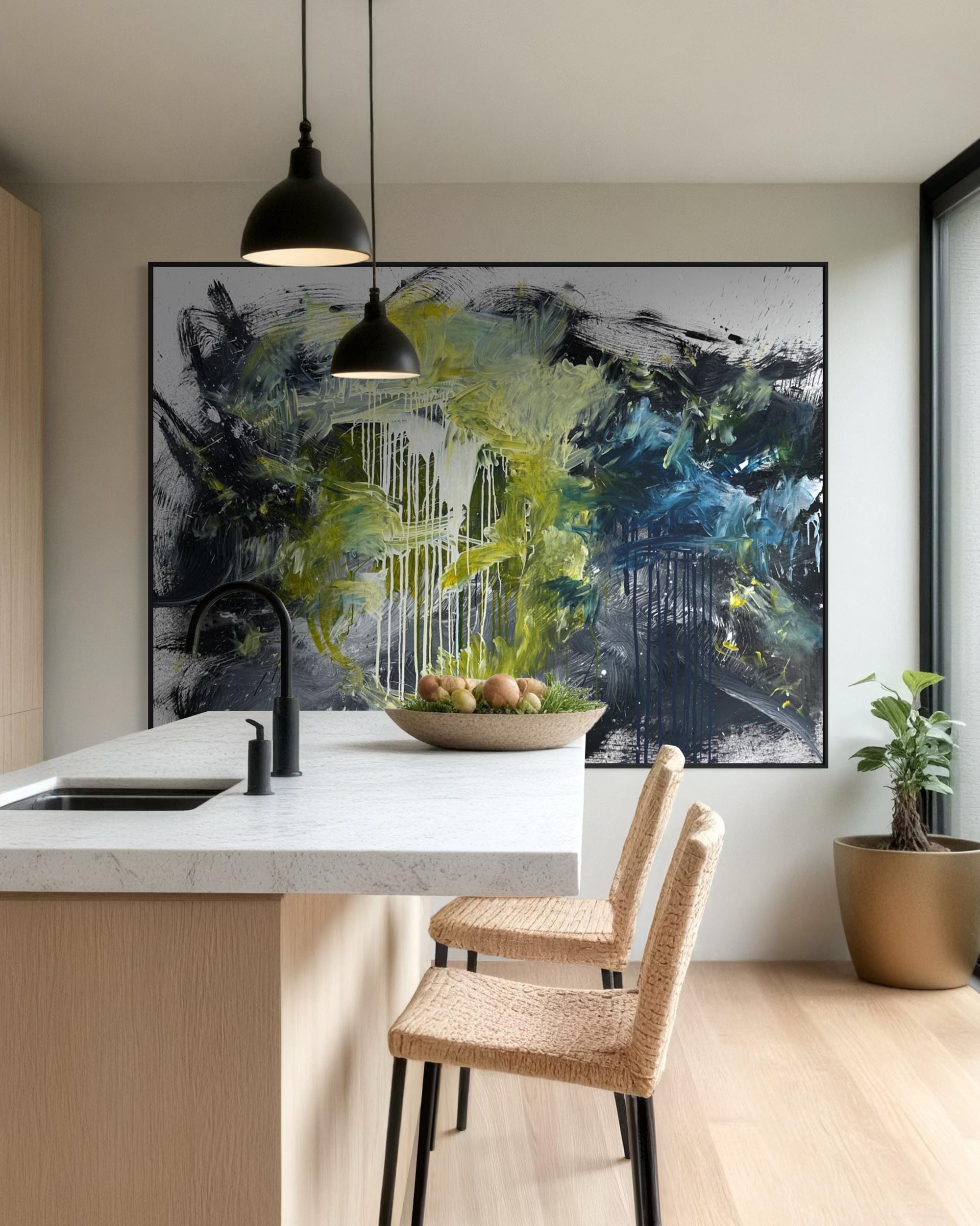 Modern kitchen with abstract art on the wall, white countertops, and wooden chairs.