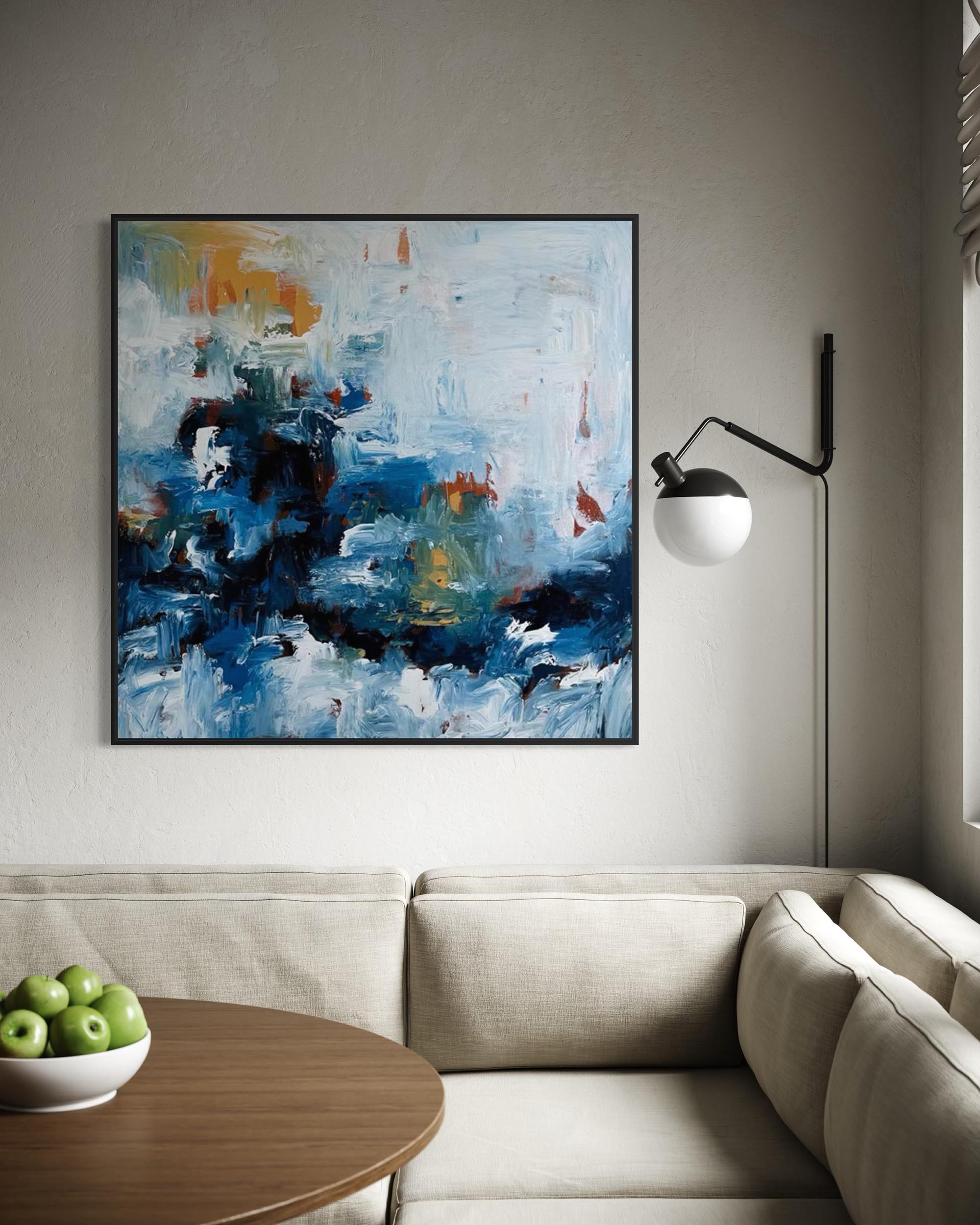 Abstract painting on a wall above a sofa in a living room