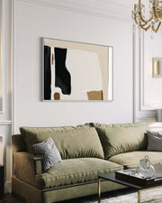 Modern living room with a green sofa, abstract art, and decorative items.