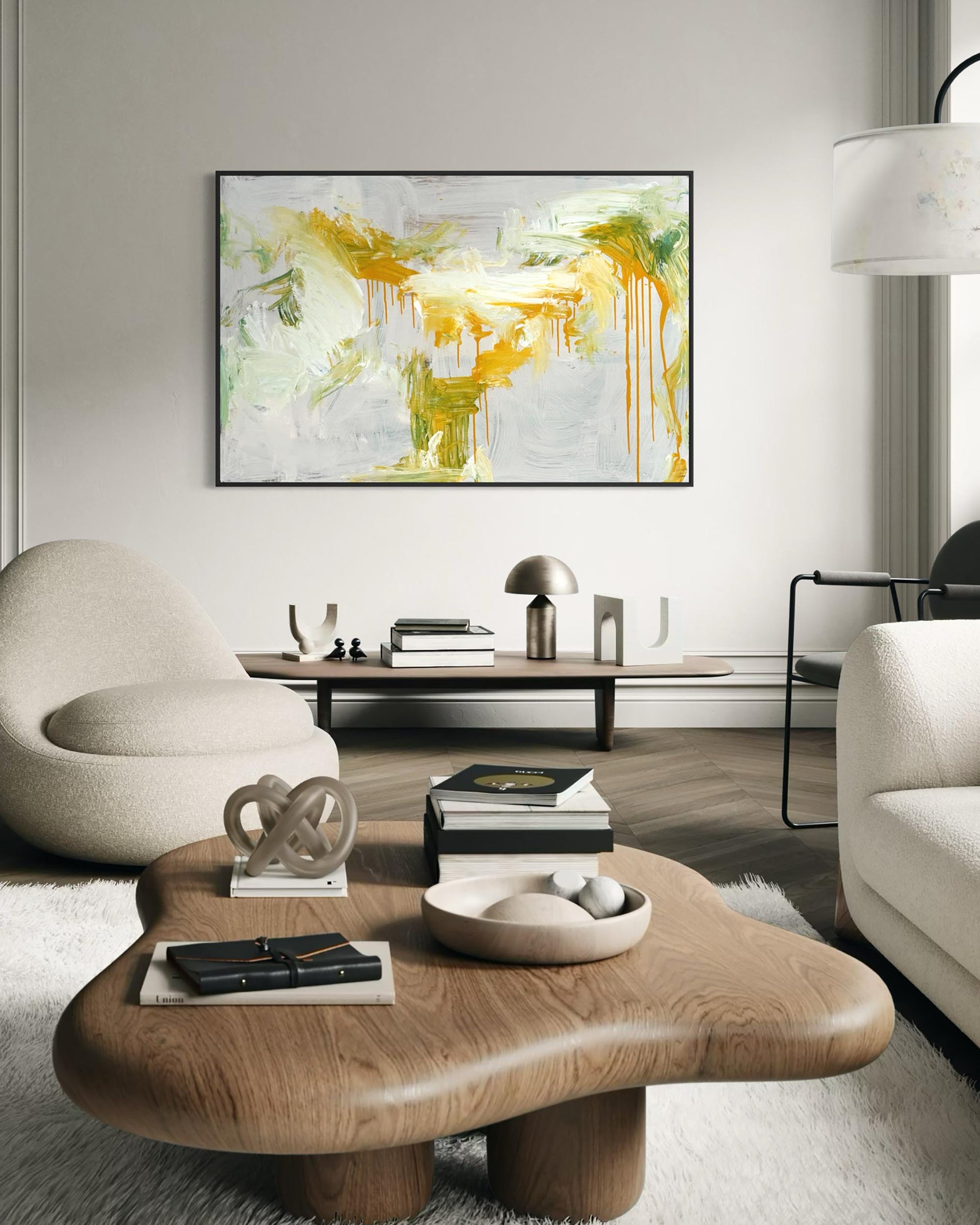 Modern living room with abstract art, coffee table, and chairs.