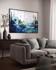 Living room with a gray sofa, coffee table, and abstract painting on the wall.