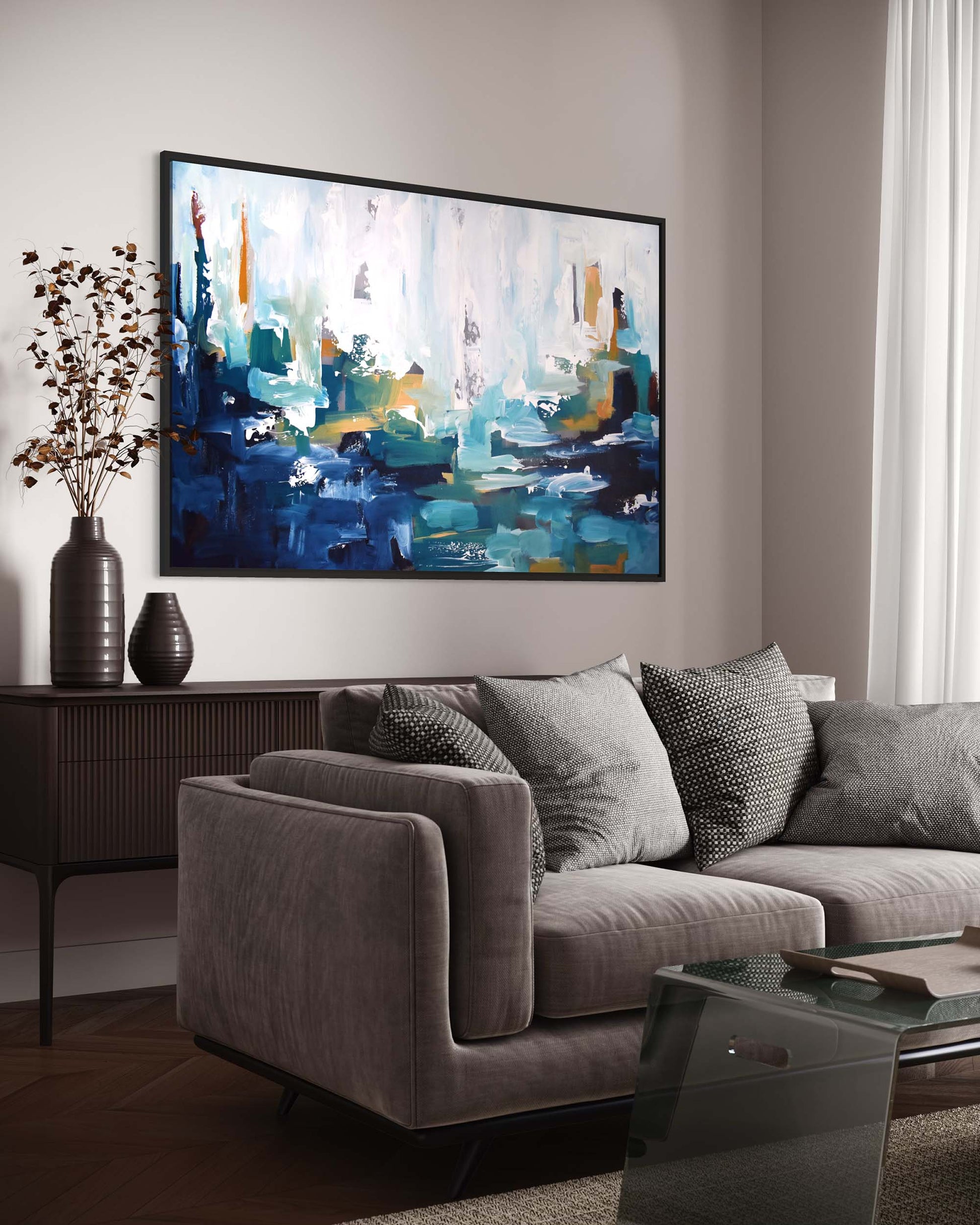 Living room with a gray sofa, coffee table, and abstract painting on the wall.