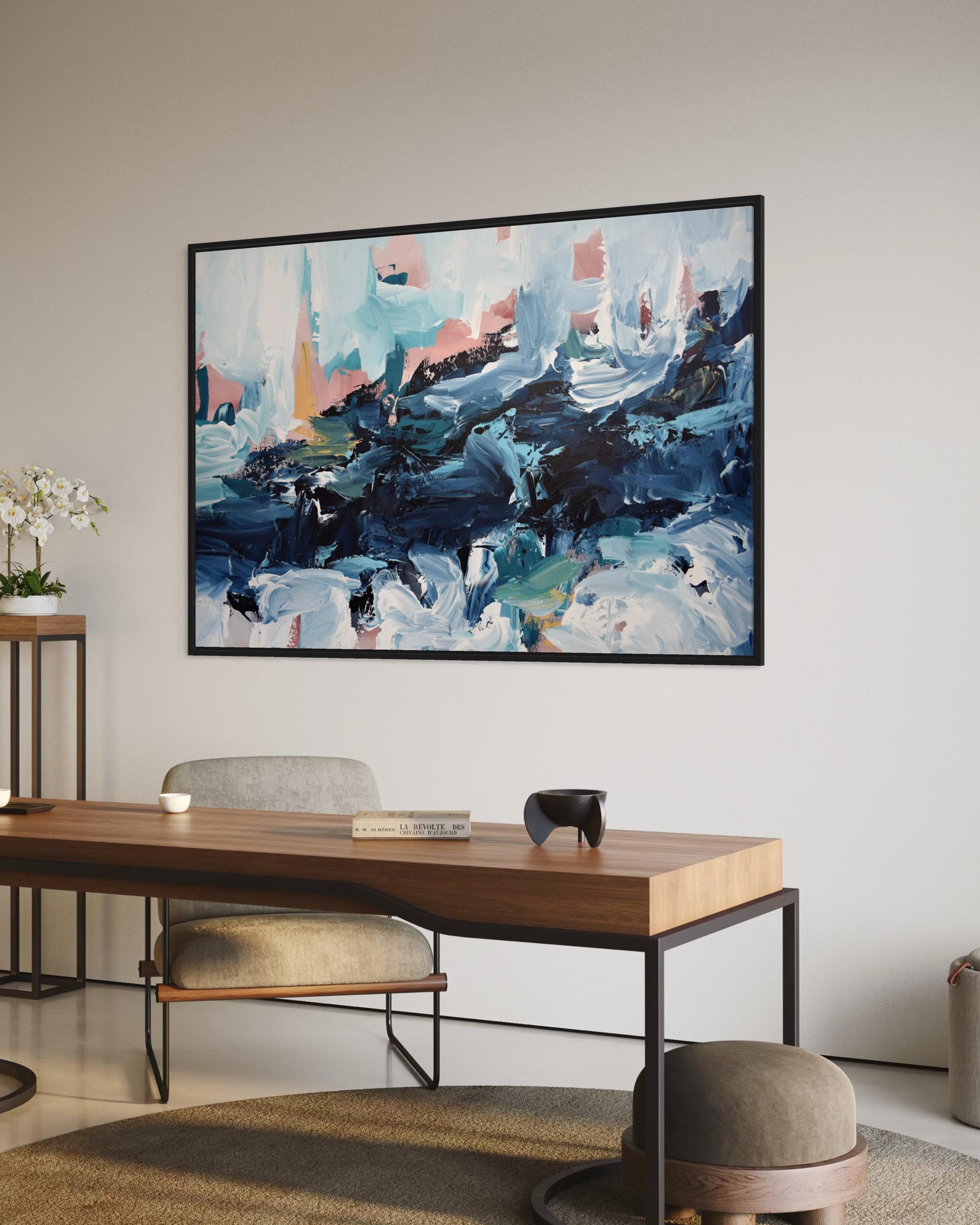 Abstract painting in a modern office setting with a desk and chairs.