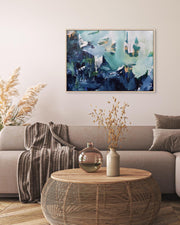 Living room with a gray sofa, wooden coffee table, and abstract painting on the wall.