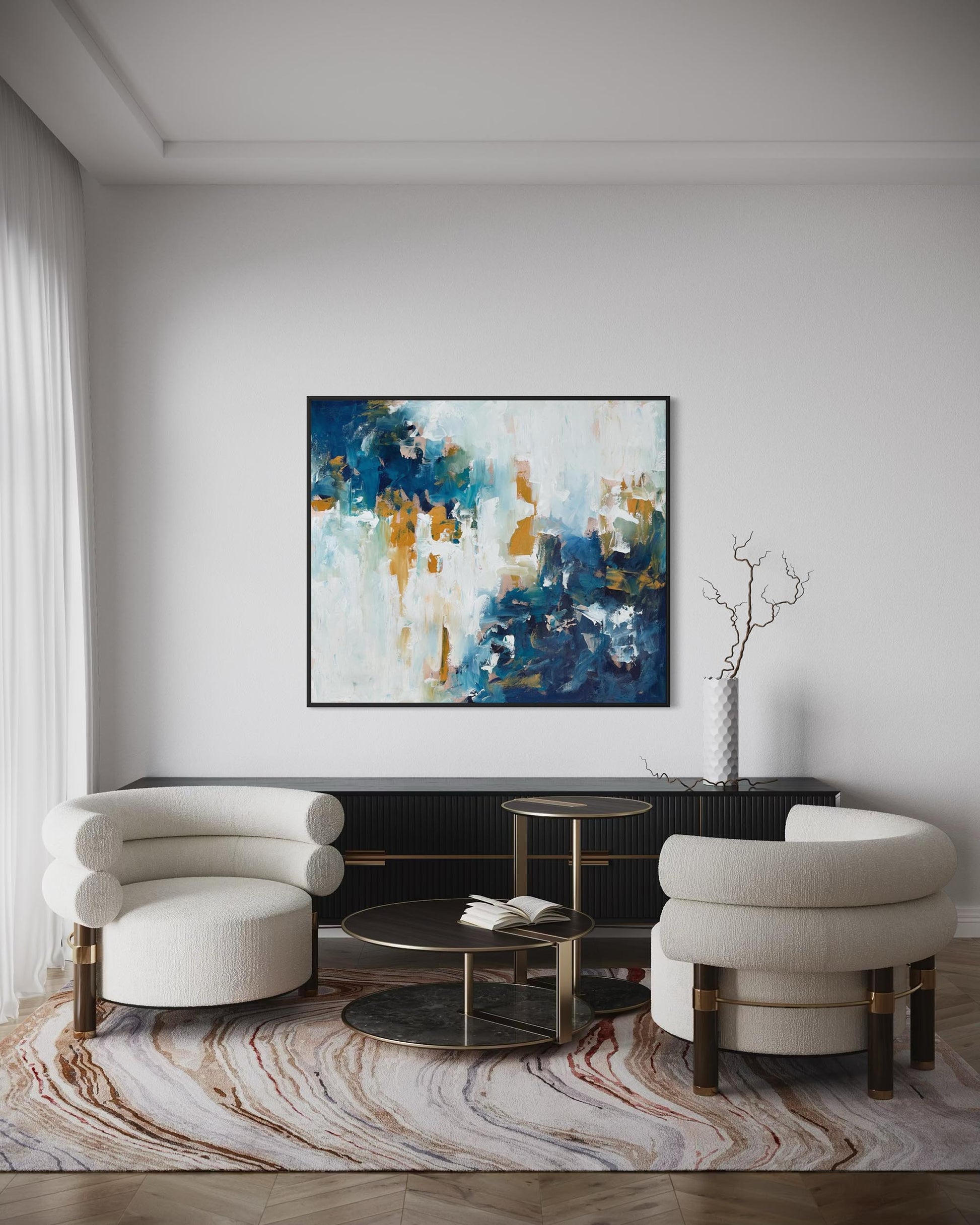 Modern living room with abstract art, white chairs, and a coffee table.