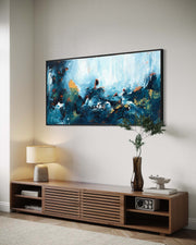 Modern living room with a large flat-screen TV displaying an abstract painting, wooden entertainment console, and decorative items.
