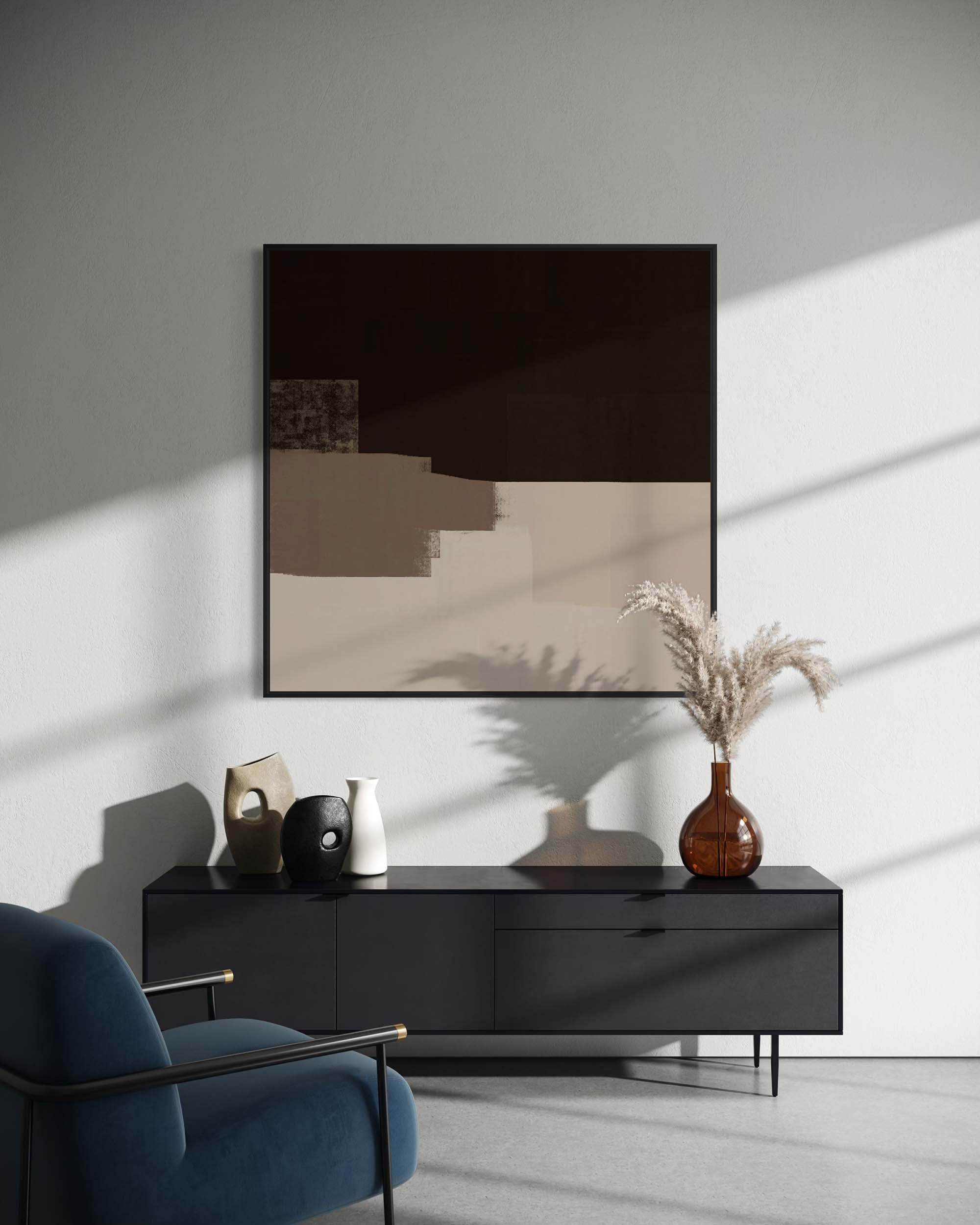 Modern living room with a black console table, blue armchair, and framed abstract art.