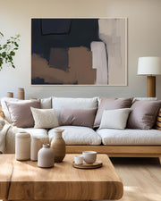 Modern living room with a beige sofa, wooden coffee table, and abstract art on the wall.