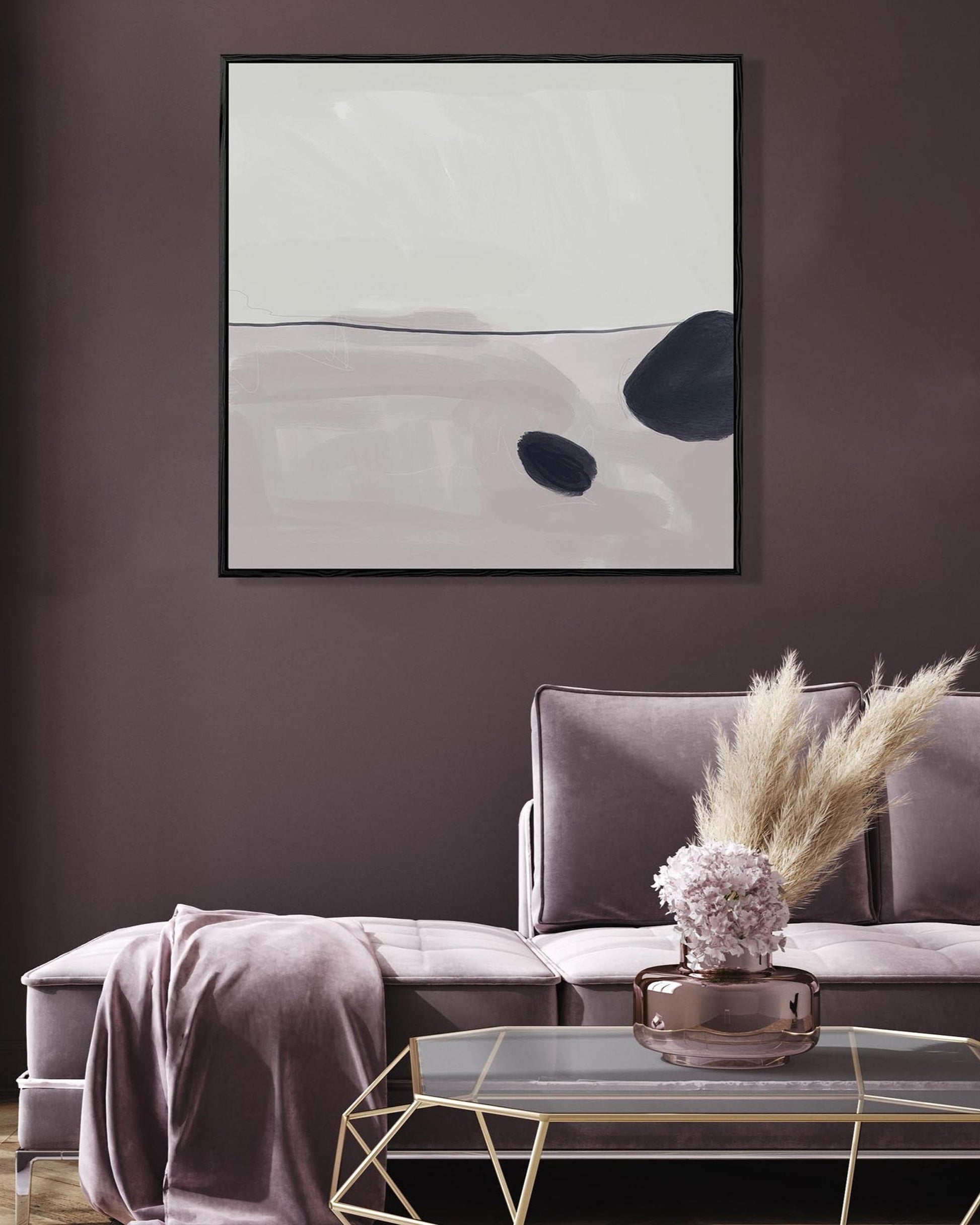 Living room with a gray sofa, abstract art on the wall, and decorative elements.