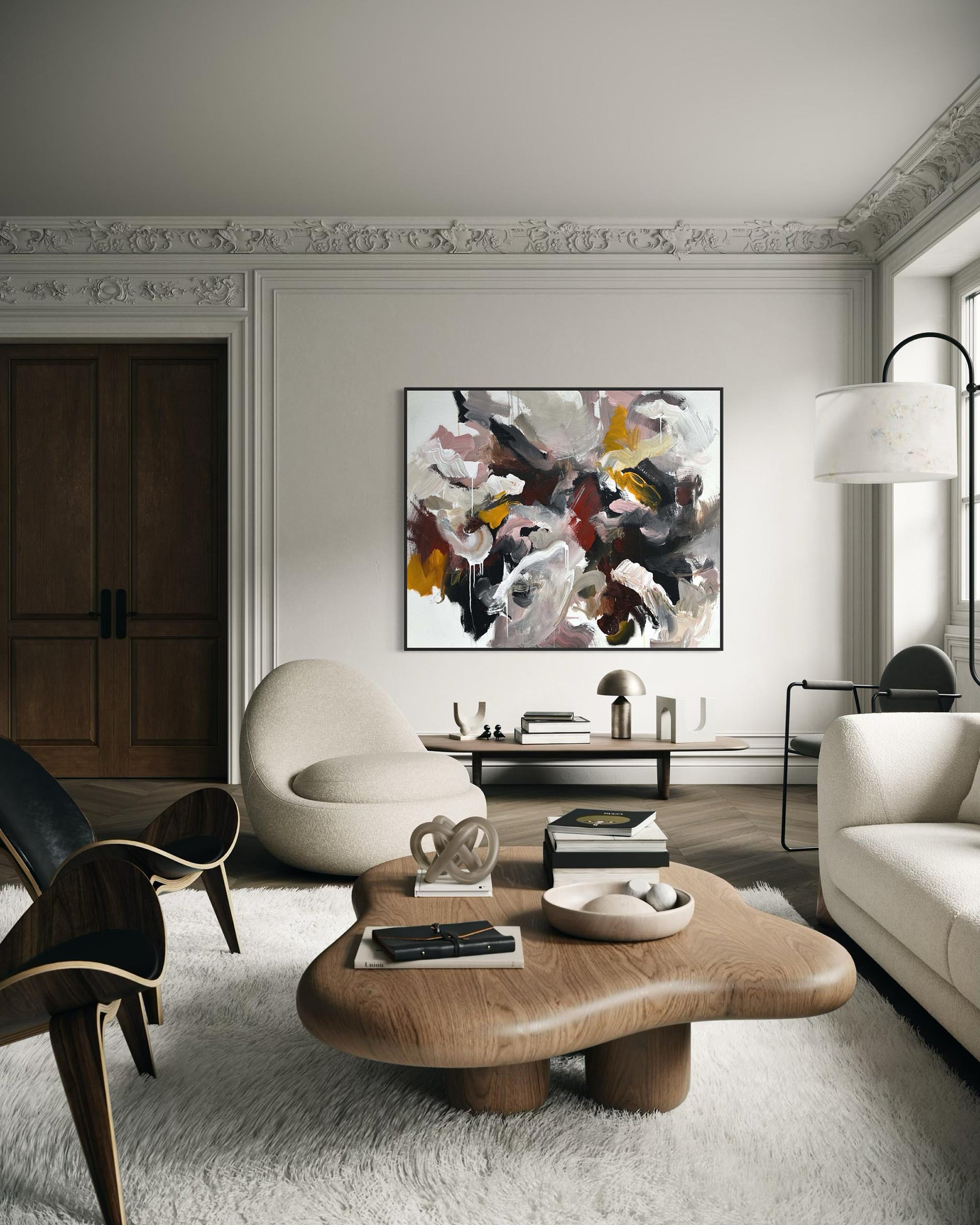 Modern living room with abstract art, wooden coffee table, and stylish furniture.