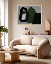 Modern living room with a beige sofa, abstract art, and decorative items.