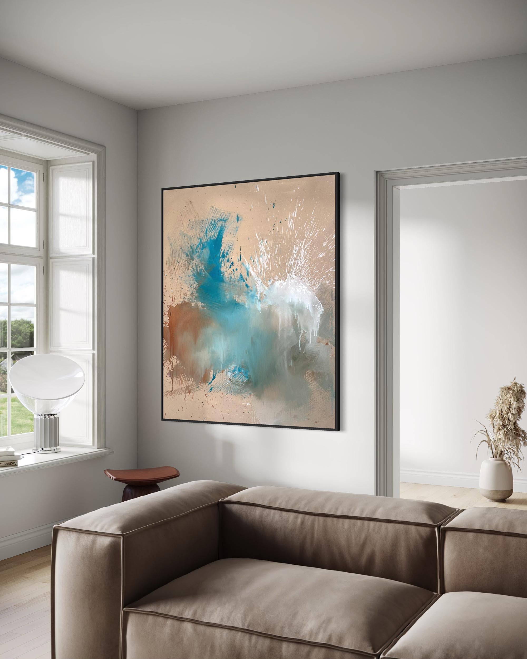 Modern living room with a large abstract painting on the wall, a beige sofa, and a window.