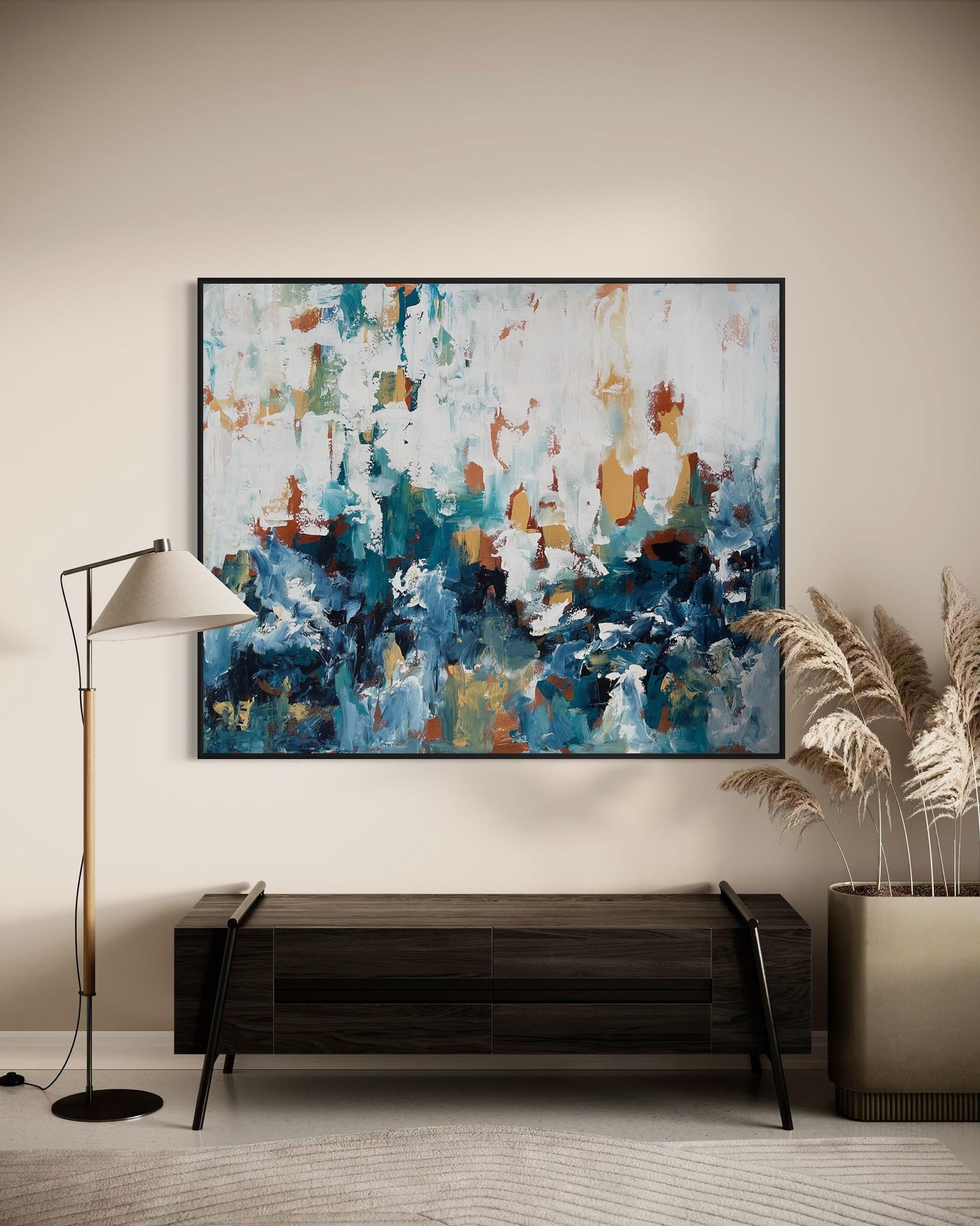 Abstract painting on a wall above a wooden console table in a room.