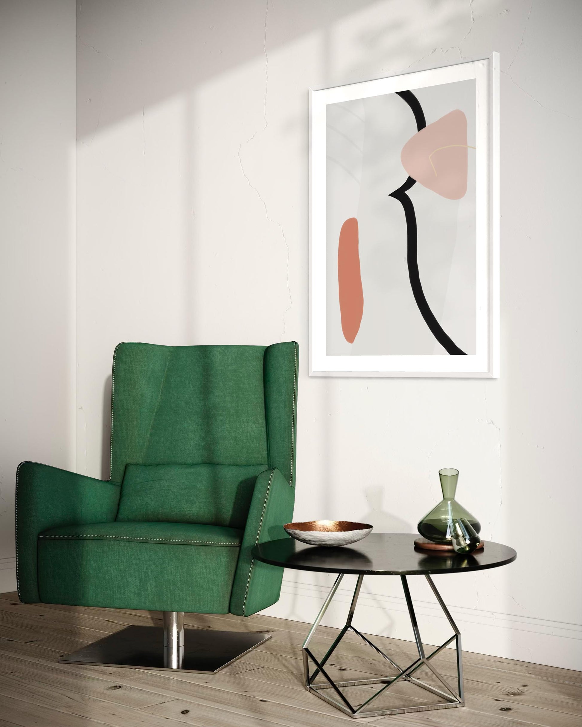Green armchair in a room with abstract art on the wall and a small table with decor items.