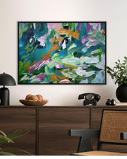 Abstract painting on a wall above a wooden cabinet with decorative items.
