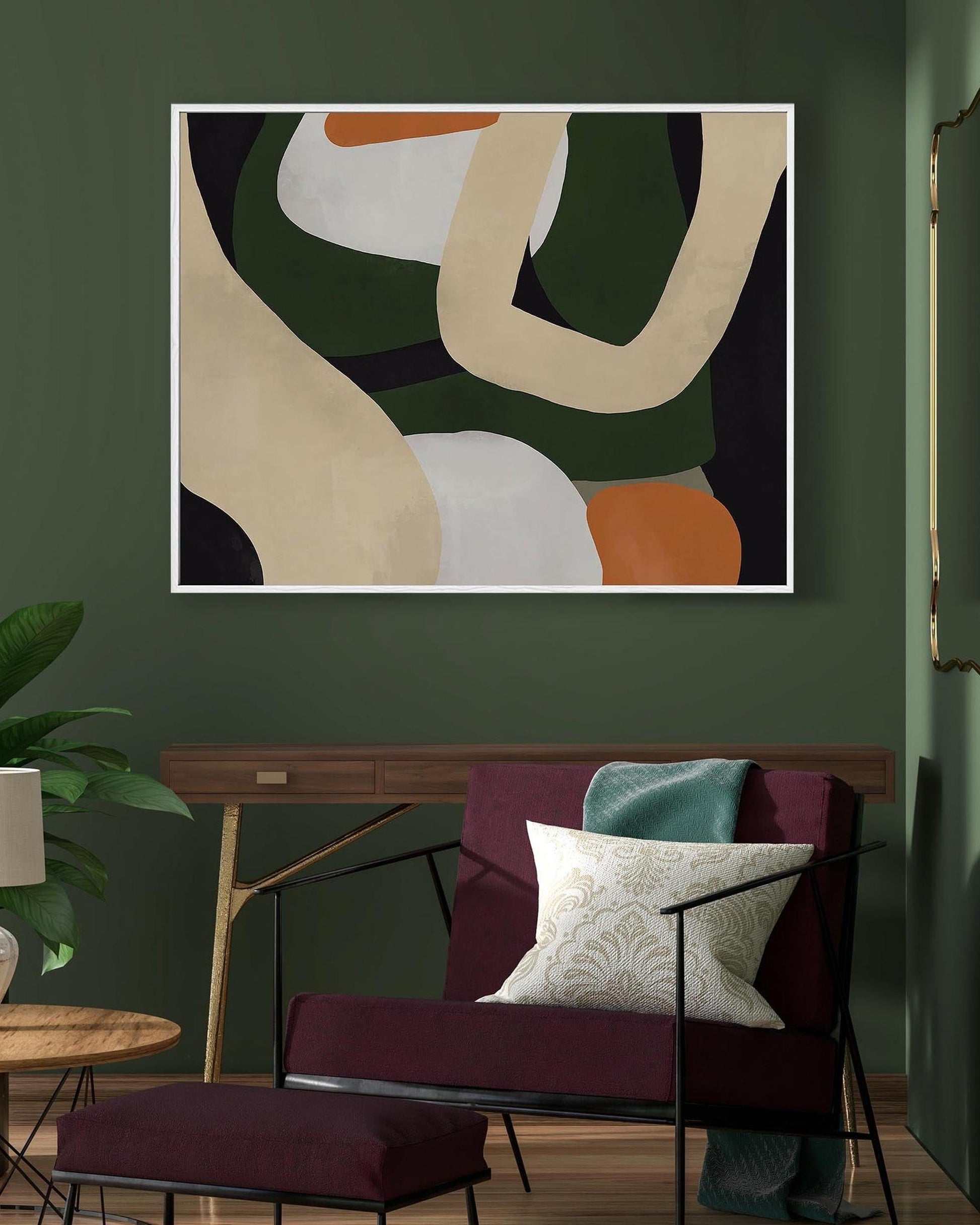 Abstract art piece on a green wall above a modern chair with a plant and side table in the foreground.