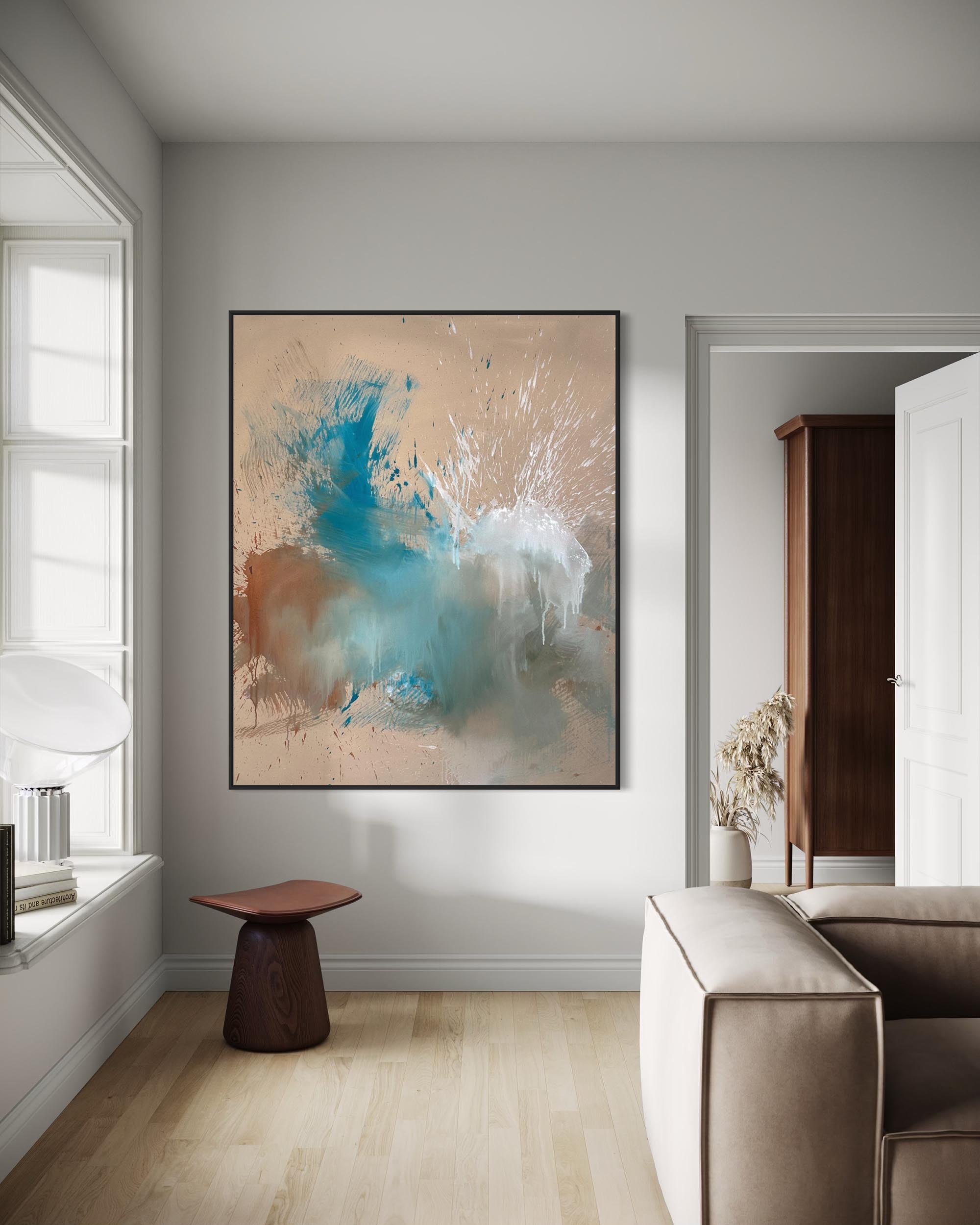 Modern living room with abstract art on the wall, a sofa, and a small table.