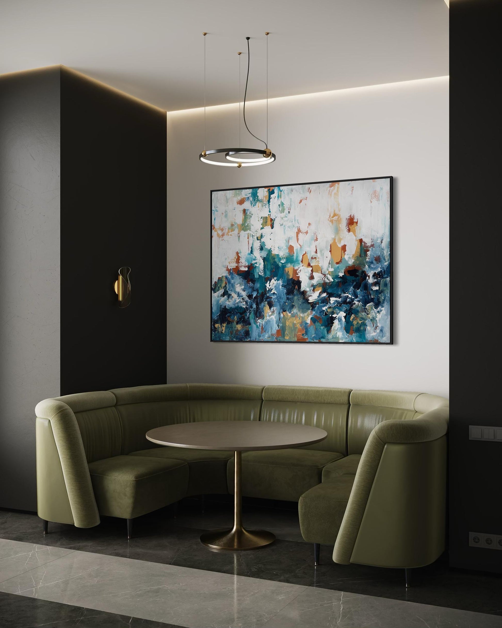 Modern interior with a green sectional sofa, round table, and abstract painting on a white wall.
