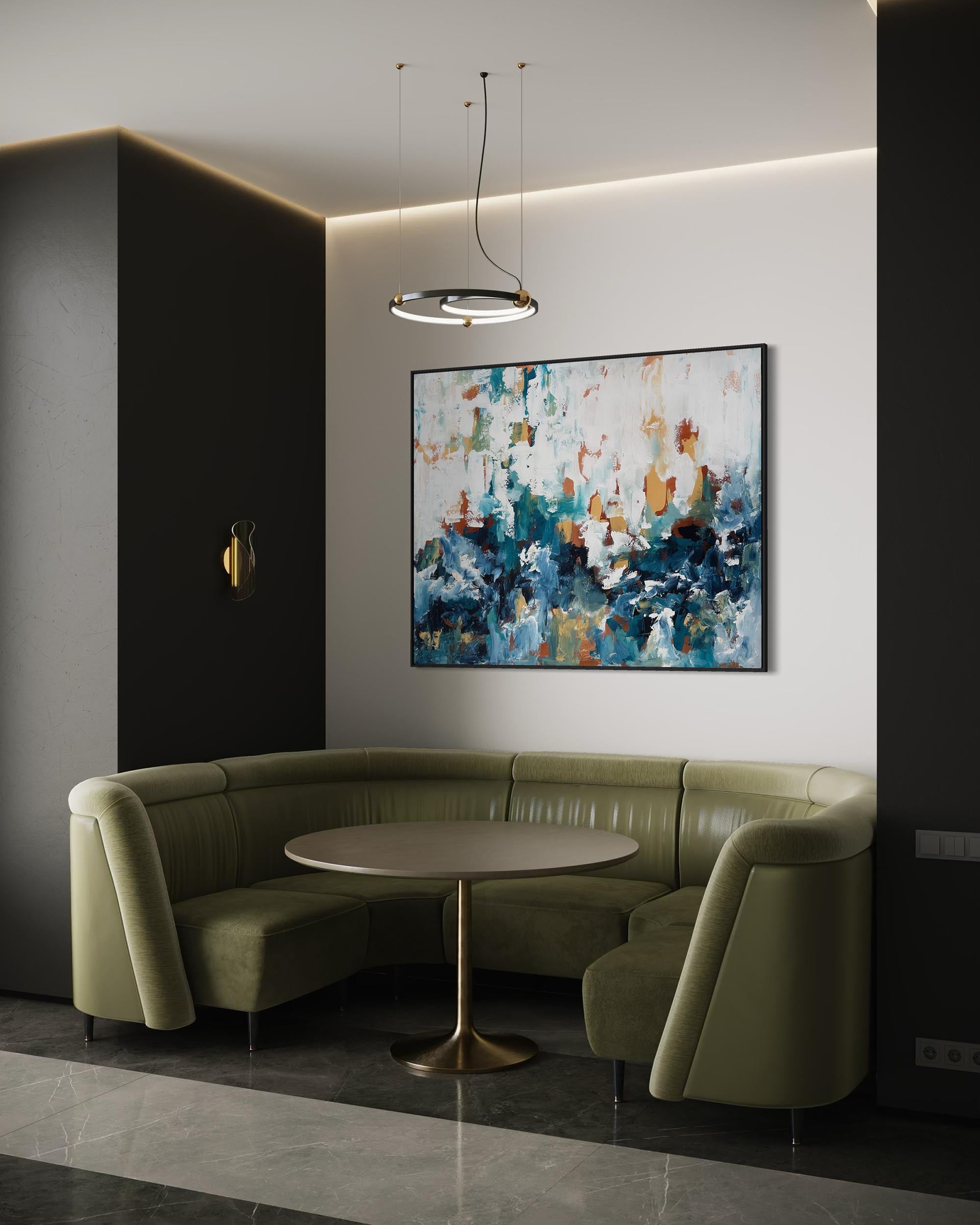 Modern interior with a green sectional sofa, round table, and abstract painting on a white wall.