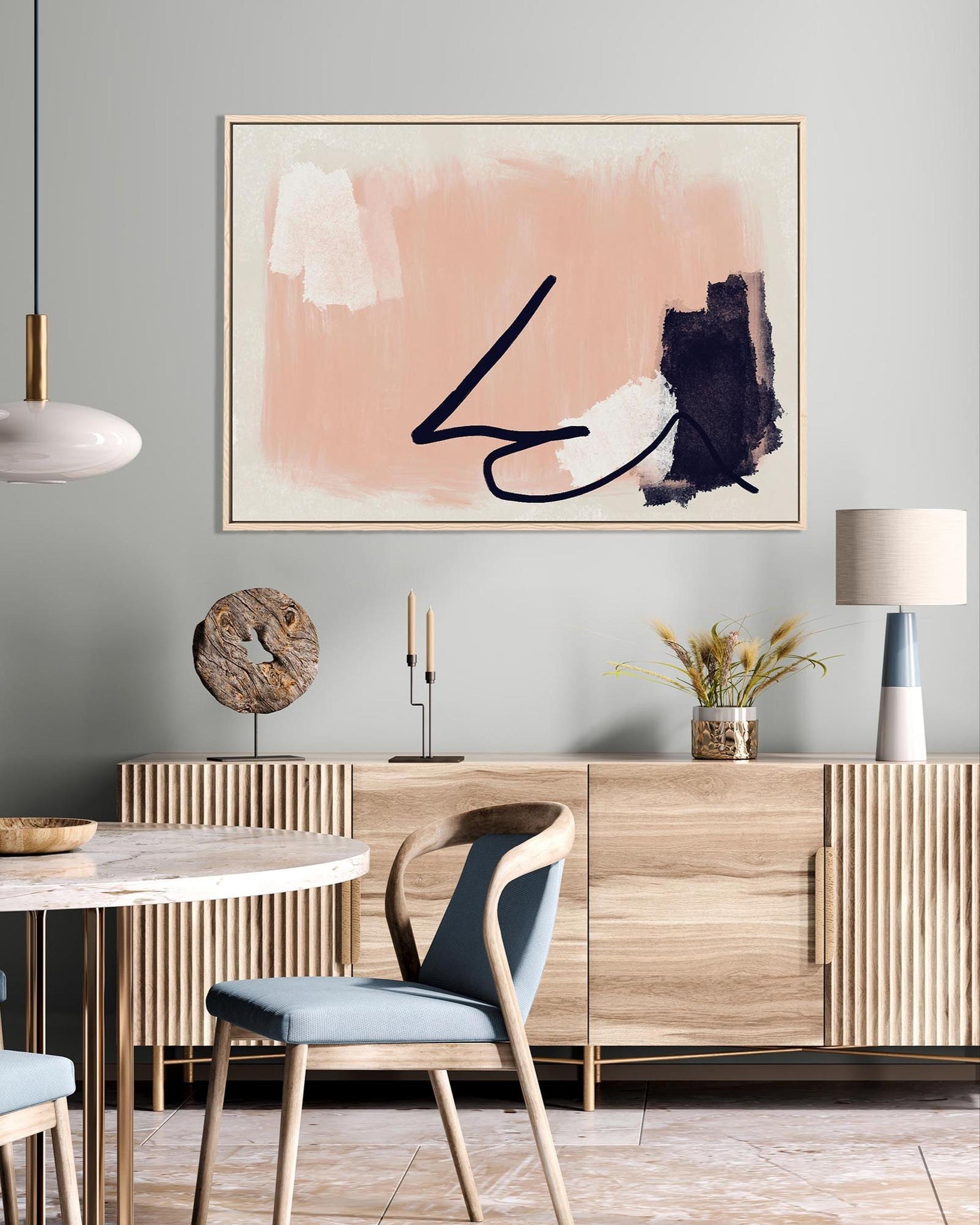 Modern dining room with wooden table, chairs, and abstract art on the wall.