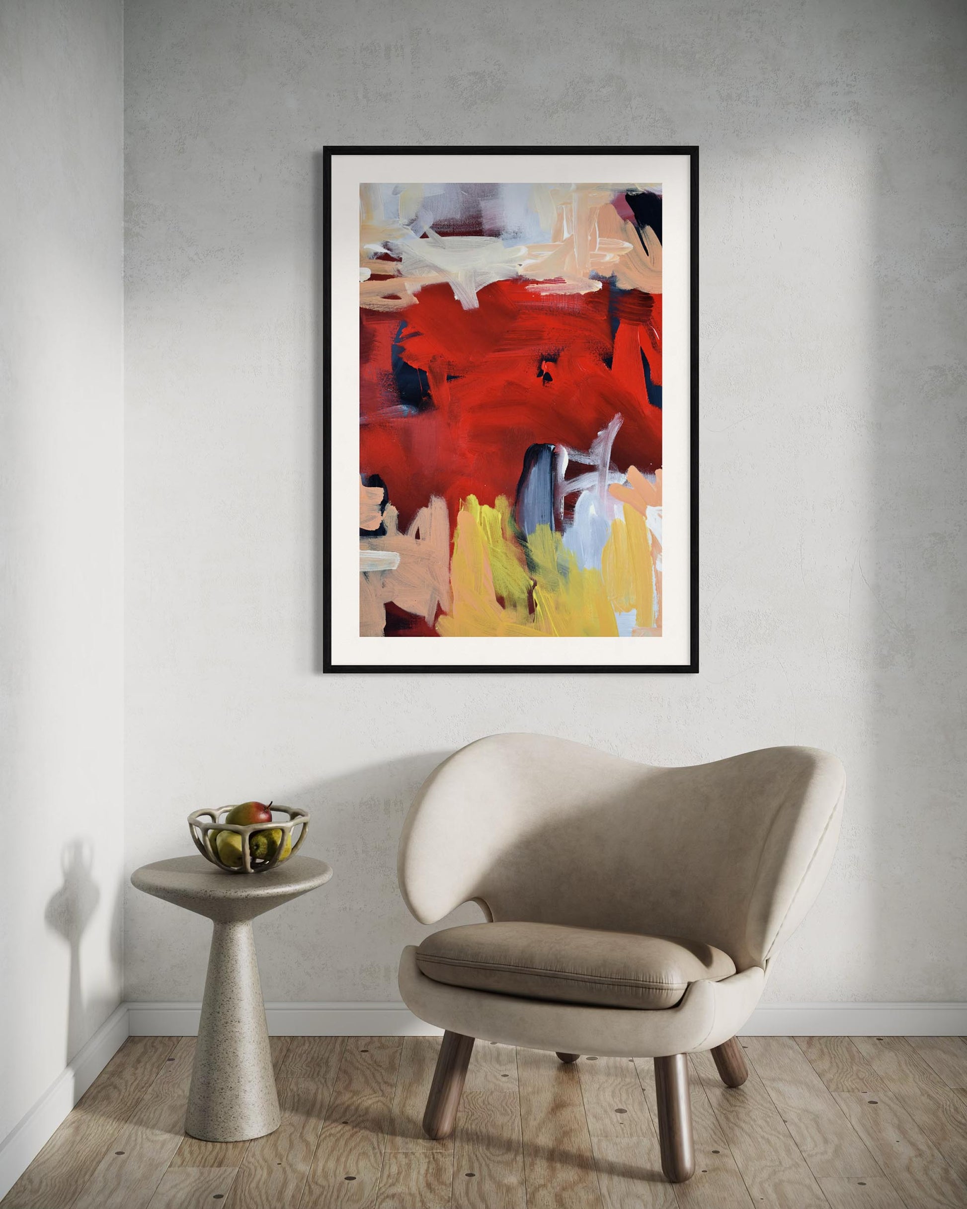 Abstract art piece on a wall above a modern chair and side table.