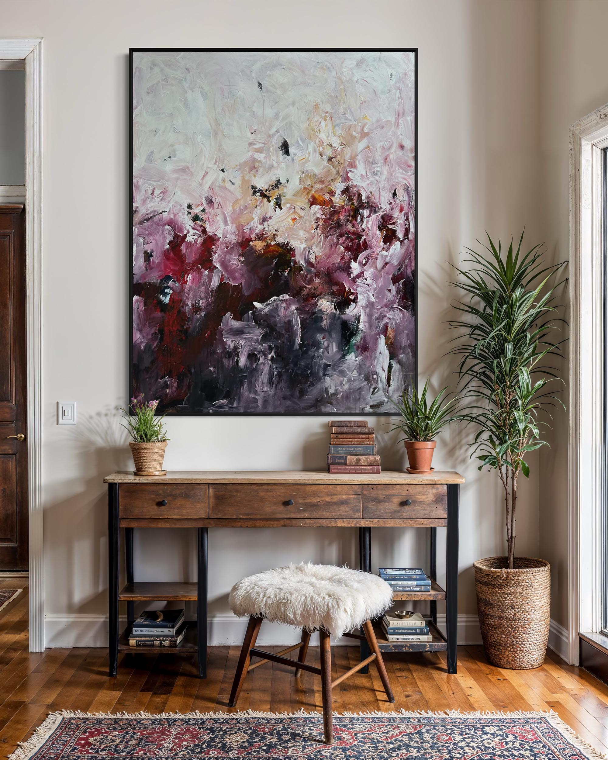 Home interior with a wooden console table, abstract painting, and decorative items.