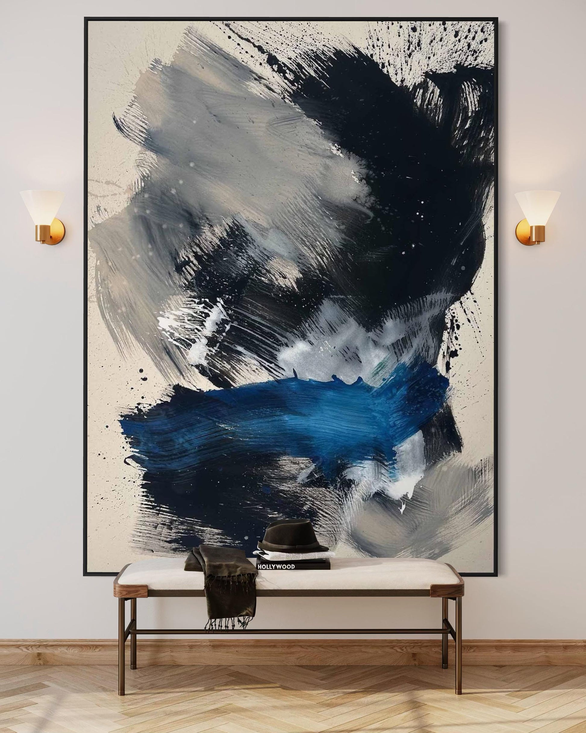 Abstract art painting in a modern interior setting with a bench and wall lights.